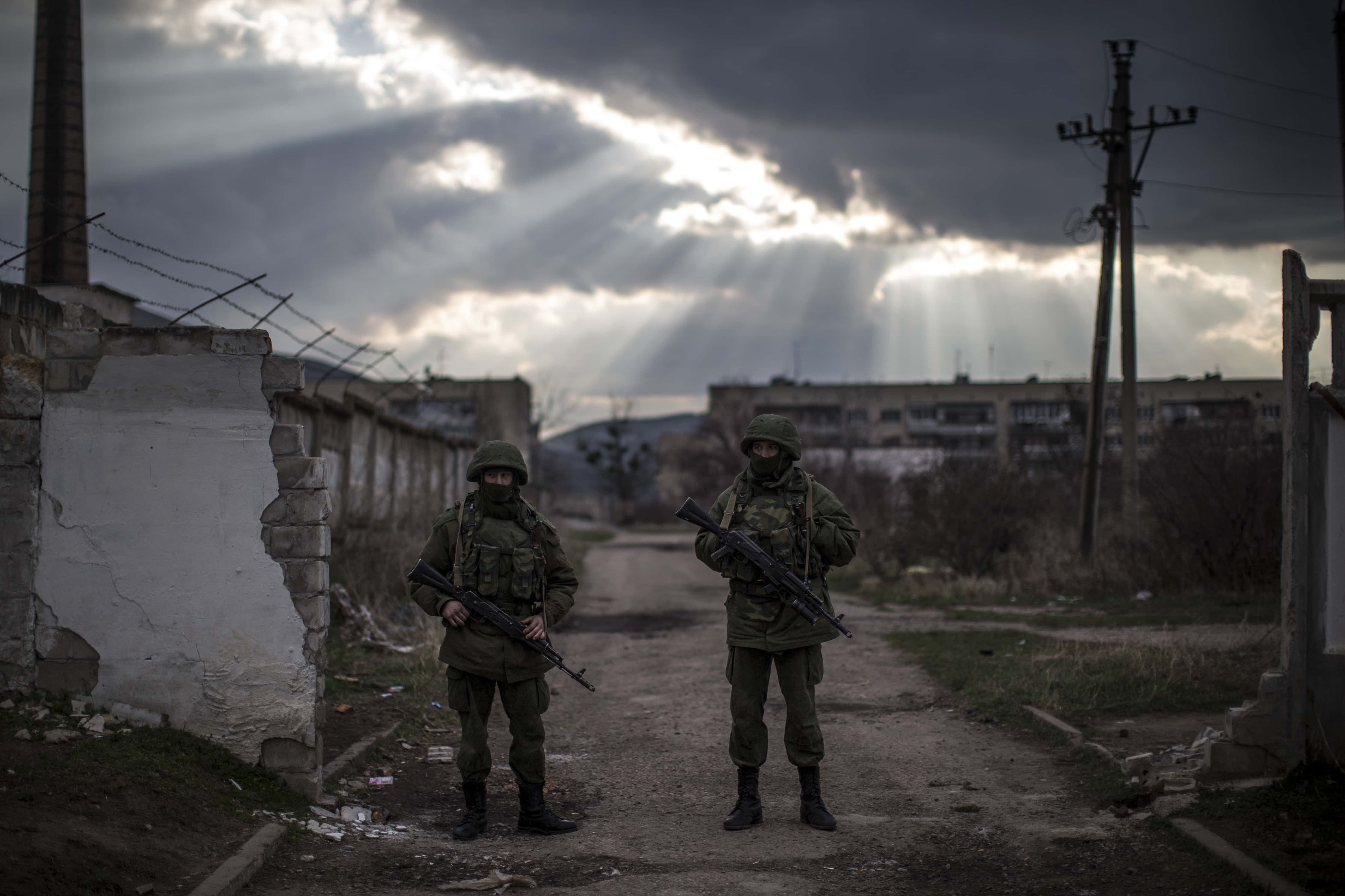Armed men believed to be Russian military stand outside a Ukrainian military base on March 12, 2014 in Simferopol, Ukraine. As the standoff between the Russian military and Ukrainian forces continues in Ukraine's Crimean peninsula, world leaders are pushing for a diplomatic solution to the escalating situation. Crimean citizens will vote in a referendum on 16 March on whether to become part of the Russian federation.