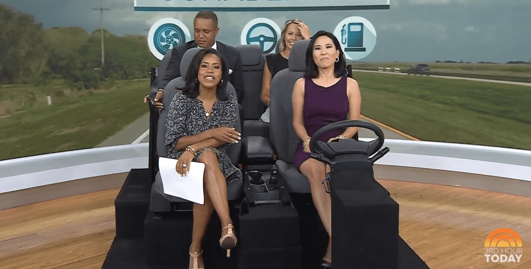 A distracted Craigh Melvin toys with the seat belt on the makeshift car on 'Today' (Twitter/@TODAYshow)