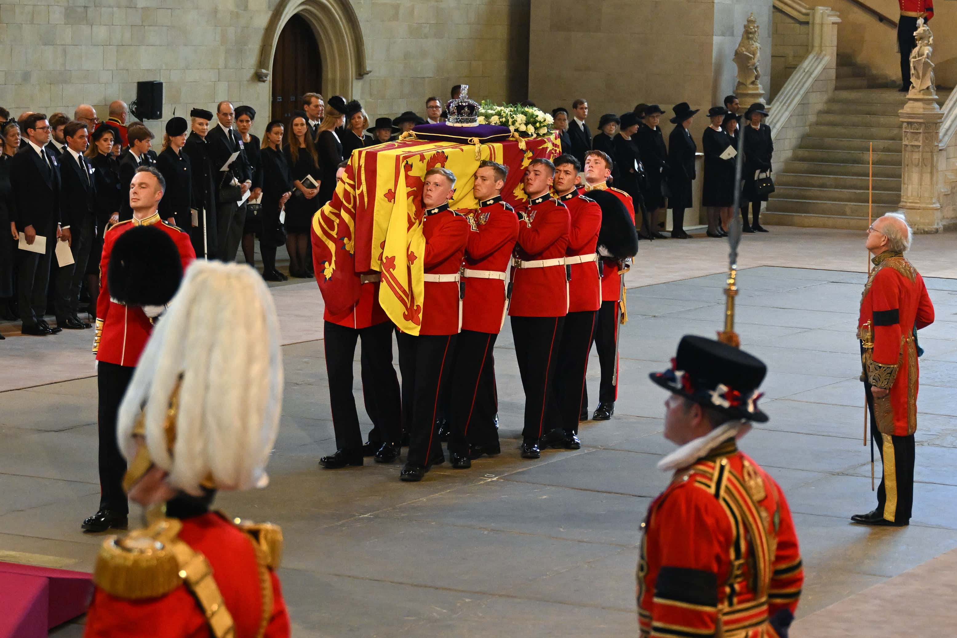 The Coffin is carried into The Palace of Westminster during the procession for the Lying-in State of Queen Elizabeth II on September 14, 2022 in London, England. Queen Elizabeth II's coffin is taken in procession on a Gun Carriage of The King's Troop Royal Horse Artillery from Buckingham Palace to Westminster Hall where she will lay in state until the early morning of her funeral. Queen Elizabeth II died at Balmoral Castle in Scotland on September 8, 2022, and is succeeded by her eldest son, King Charles III.