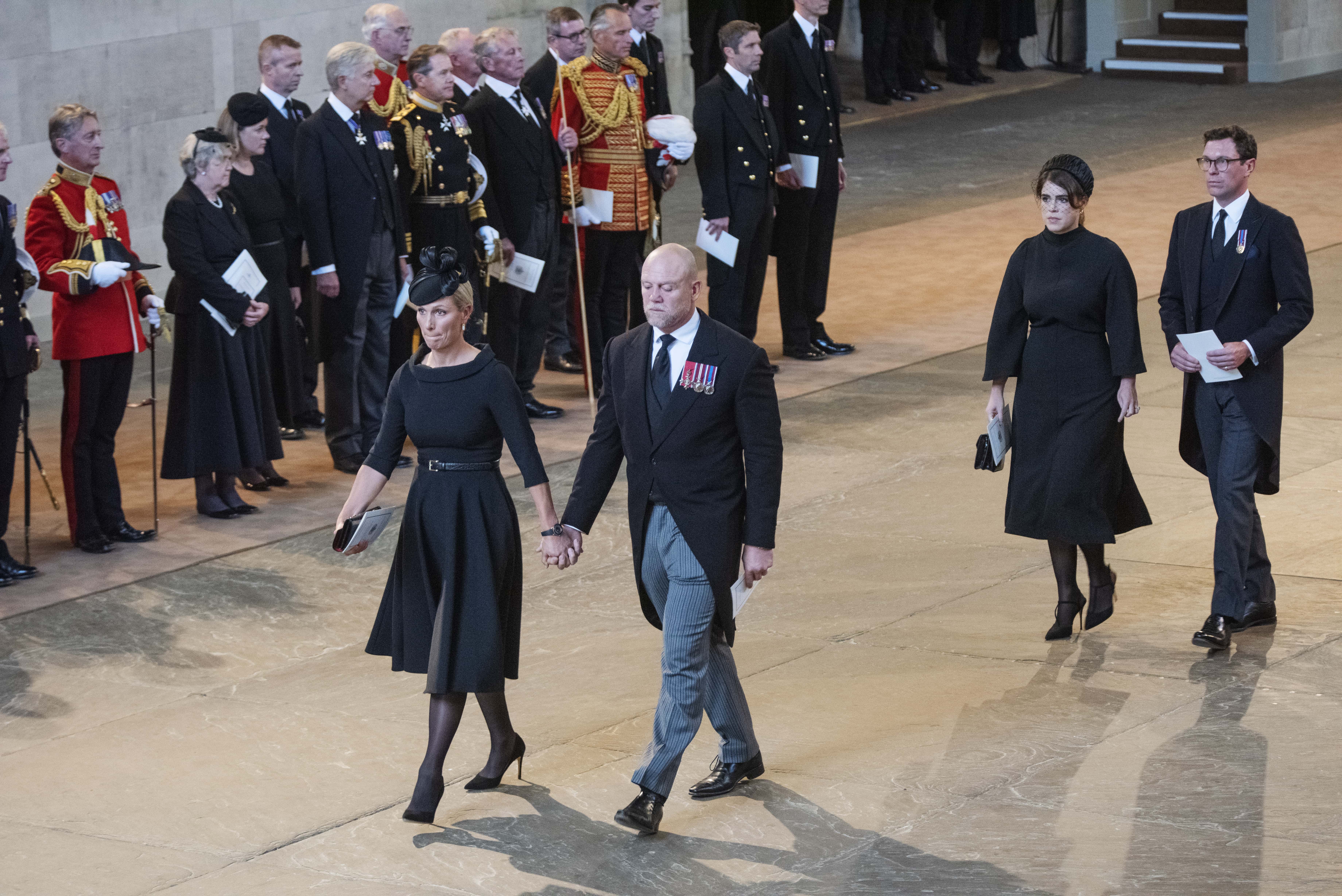 Zara Tindall, Mike Tindall, Princess Eugenie and Jack Brooksbank leave the service for the reception of Queen Elizabeth II's coffin at Westminster Hall on September 14, 2022 in London, England. Queen Elizabeth II's coffin is taken in procession on a Gun Carriage of The King's Troop Royal Horse Artillery from Buckingham Palace to Westminster Hall where she will lay in state until the early morning of her funeral. Queen Elizabeth II died at Balmoral Castle in Scotland on September 8, 2022, and is succeeded by her eldest son, King Charles III. (Photo by Linda Nylind - WPA Pool/Getty Images)