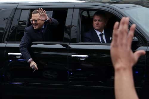 Actor Johnny Depp waves to supporters from his vehicle as he leaves a Fairfax County Courthouse May 27, 2022 in Fairfax, Virginia. Jury has started deliberation in the Depp v. Heard defamation trial, brought by Johnny Depp against his ex-wife Amber Heard. (Photo by Alex Wong/Getty Images)