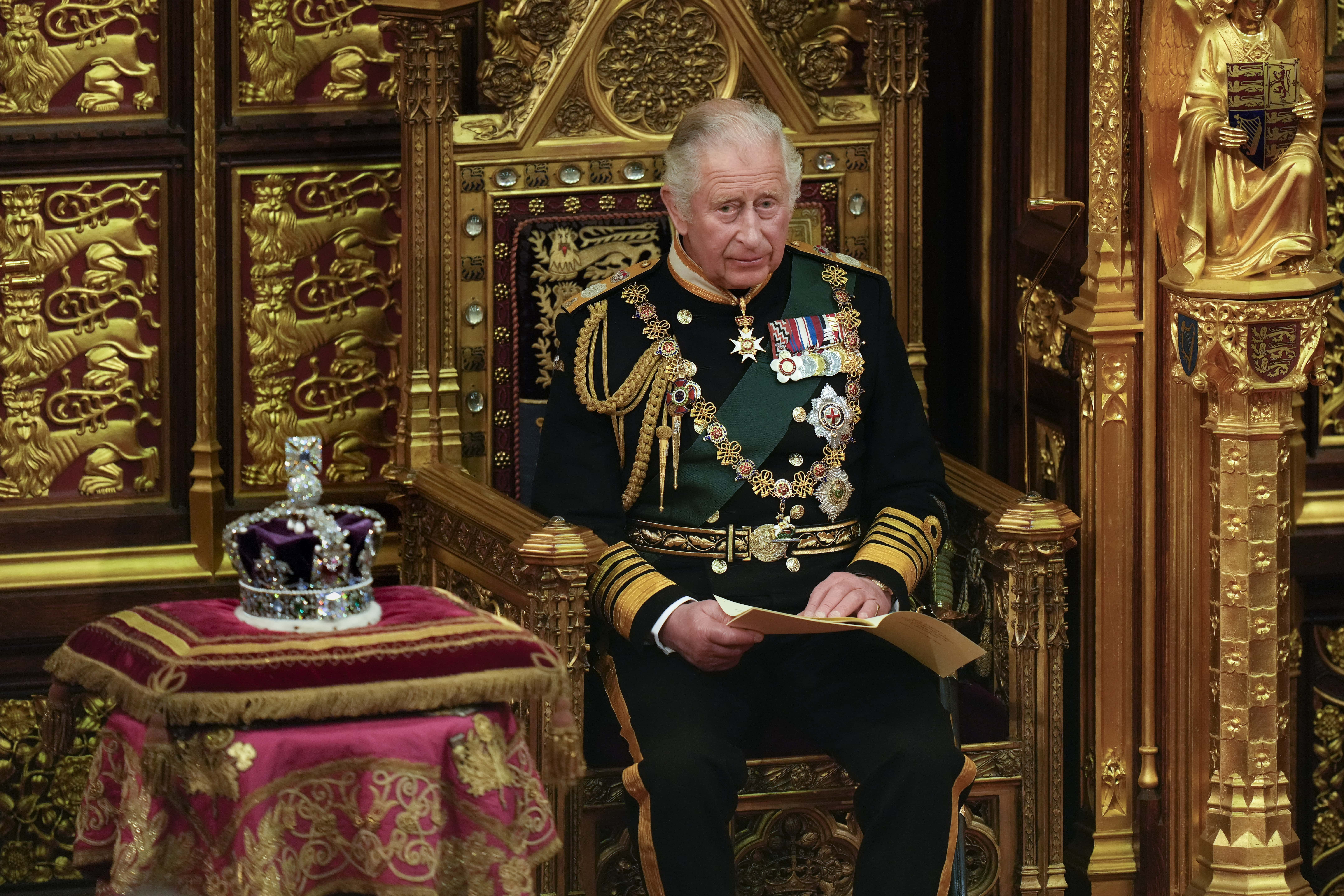Prince Charles, Prince of Wales reads the Queen's speech next to her Imperial State Crown in the House of Lords Chamber, during the State Opening of Parliament in the House of Lords at the Palace of Westminster on May 10, 2022 in London, England. The State Opening of Parliament formally marks the beginning of the new session of Parliament. It includes Queen's Speech, prepared for her to read from the throne, by her government outlining its plans for new laws being brought forward in the coming parliamentary year. This year the speech will be read by the Prince of Wales as HM The Queen will miss the event due to ongoing mobility issues.