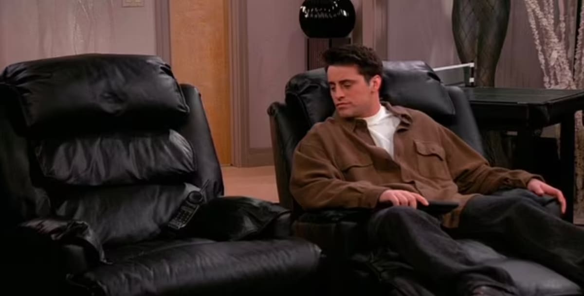 Joey looking glumly at Chandler's chair (NBC)