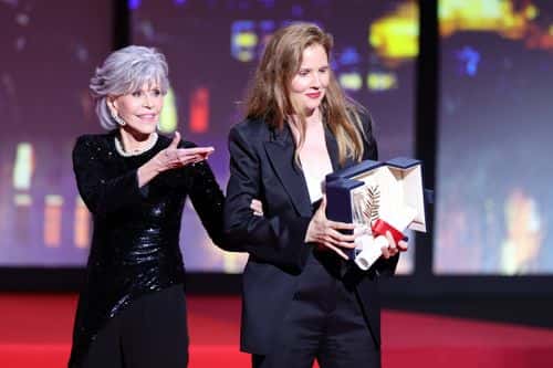 Justine Triet (R) receives The Palme D'Or Award for 'Anatomy of a Fall' from Jane Fonda (L) during the closing ceremony during the 76th annual Cannes film festival at Palais des Festivals on May 27, 2023 in Cannes, France.