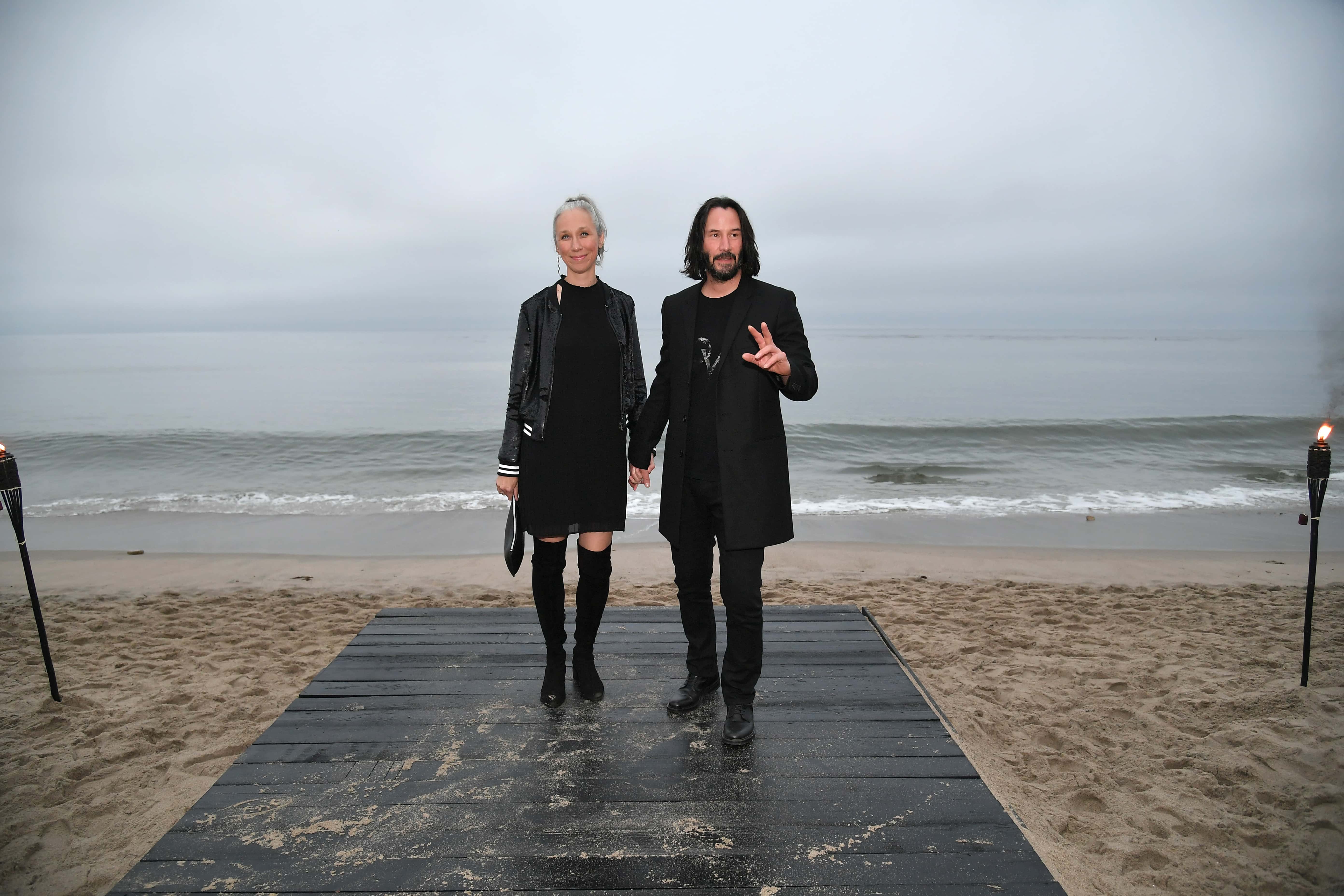 (L-R) Alexandra Grant and Keanu Reeves attend the Saint Laurent Mens Spring Summer 20 Show Photo Call on June 06, 2019, in Malibu, California. (Photo by Neilson Barnard/Getty Images)