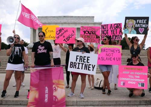 Supporters of pop star Britney Spears participate in a #FreeBritney rally at the Lincoln memorial on July 14, 2021 in Washington, DC. The group is calling for an end to the 13-year conservatorship lead by the pop star's father, Jamie Spears and Jodi Montgomery, who have control over her finances and business dealings. Planned co-conservator Bessemer Trust is petitioning the court to resign from its position after Britney Spears spoke out in court about the conservatorship.
