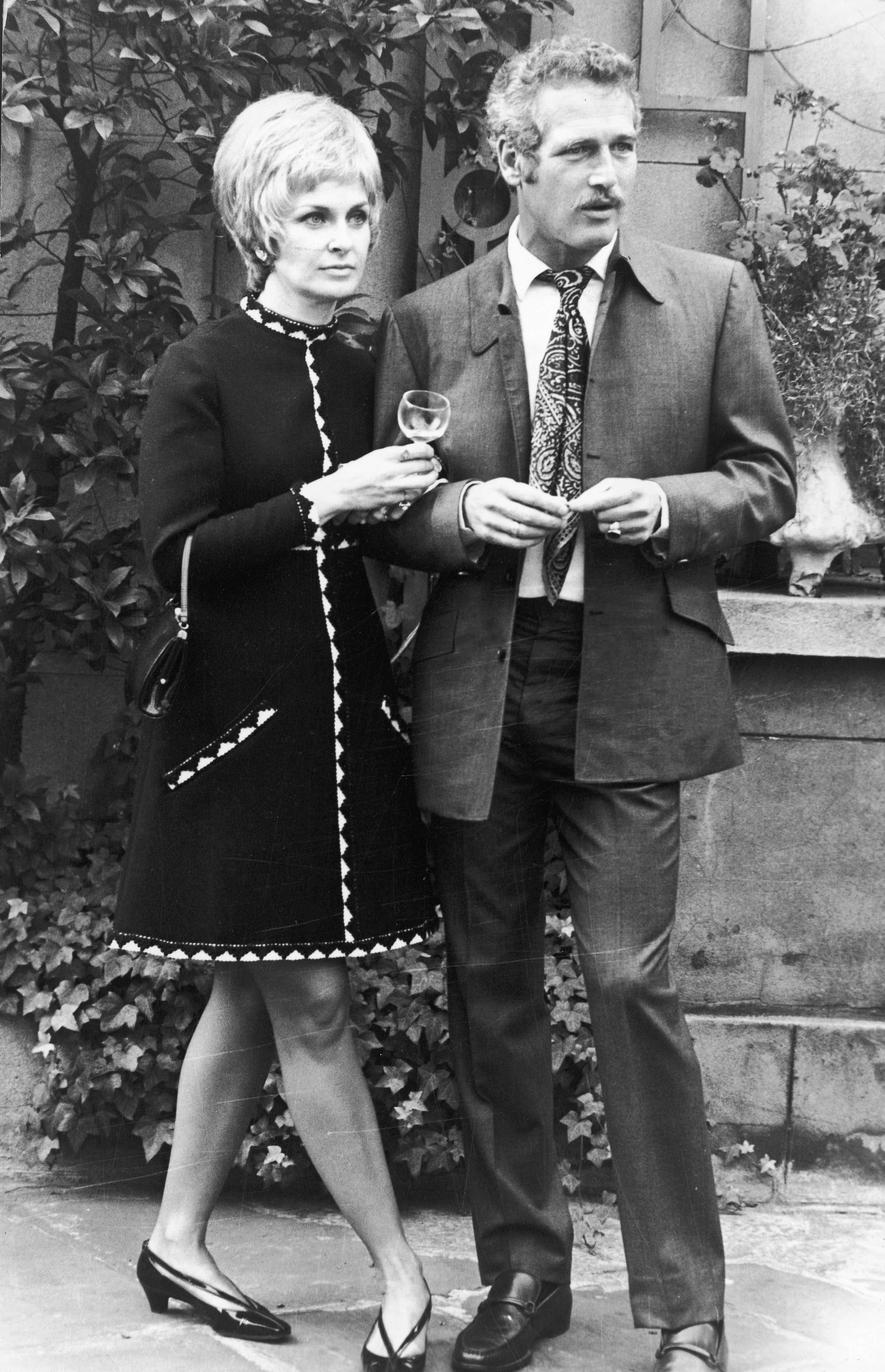 Married American actors Paul Newman and Joanne Woodward stand together outdoors while attending a party held in their honor, England, October 14, 1969. (Photo by Express Newspapers/Getty Images)