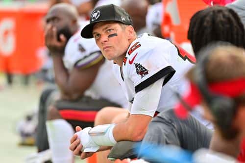 Tom Brady #12 of the Tampa Bay Buccaneers sits on the bench during the fourth quarter against the Carolina Panthers at Raymond James Stadium on January 01, 2023 in Tampa, Florida.