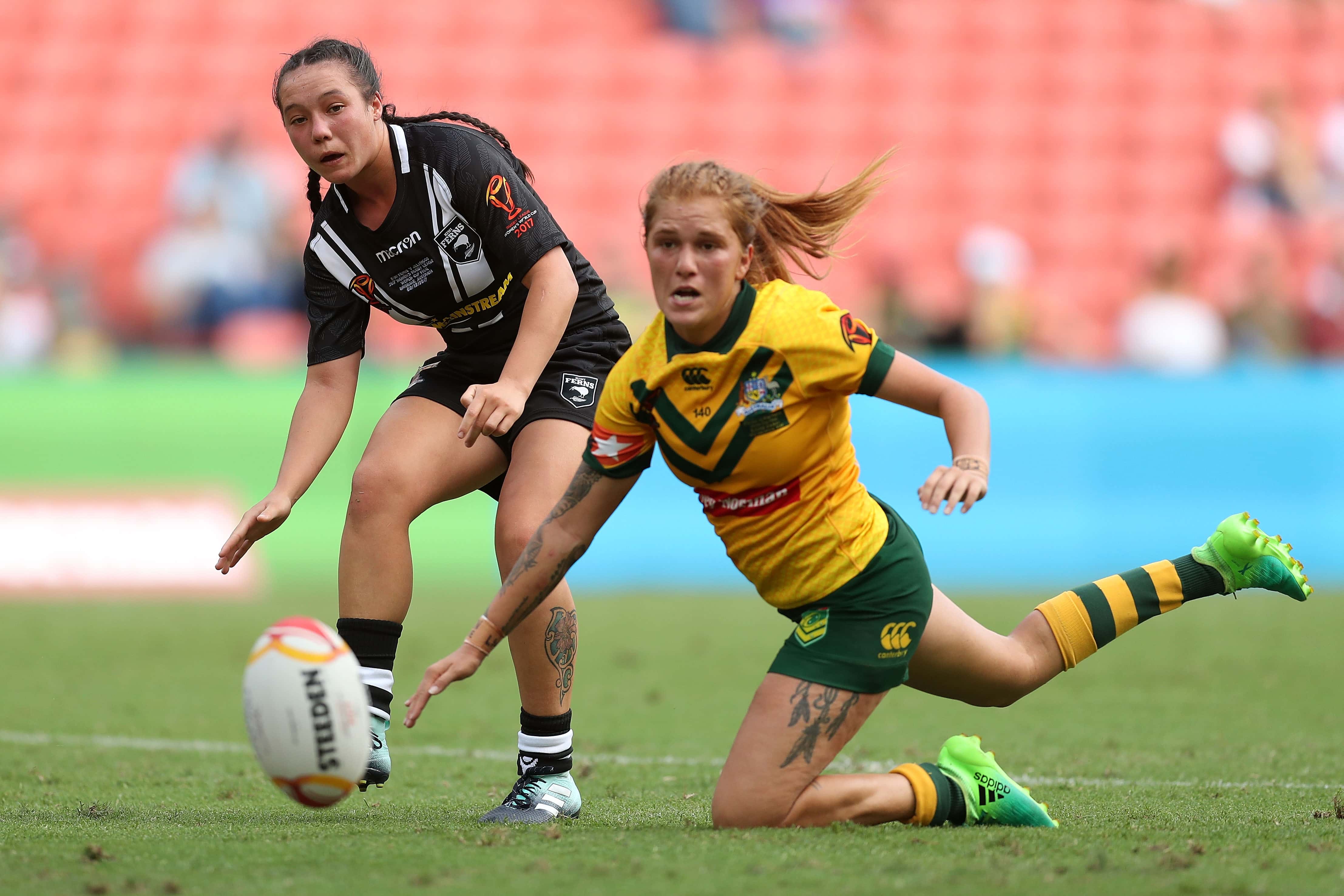 Raecene McGregor of the Ferns kicks the ball as Caitlin Moran of the Jillaroos looks on during the 2017 Rugby League Women's World Cup Final between Australia and New Zealand at Suncorp Stadium on December 2, 2017 in Brisbane, Australia.