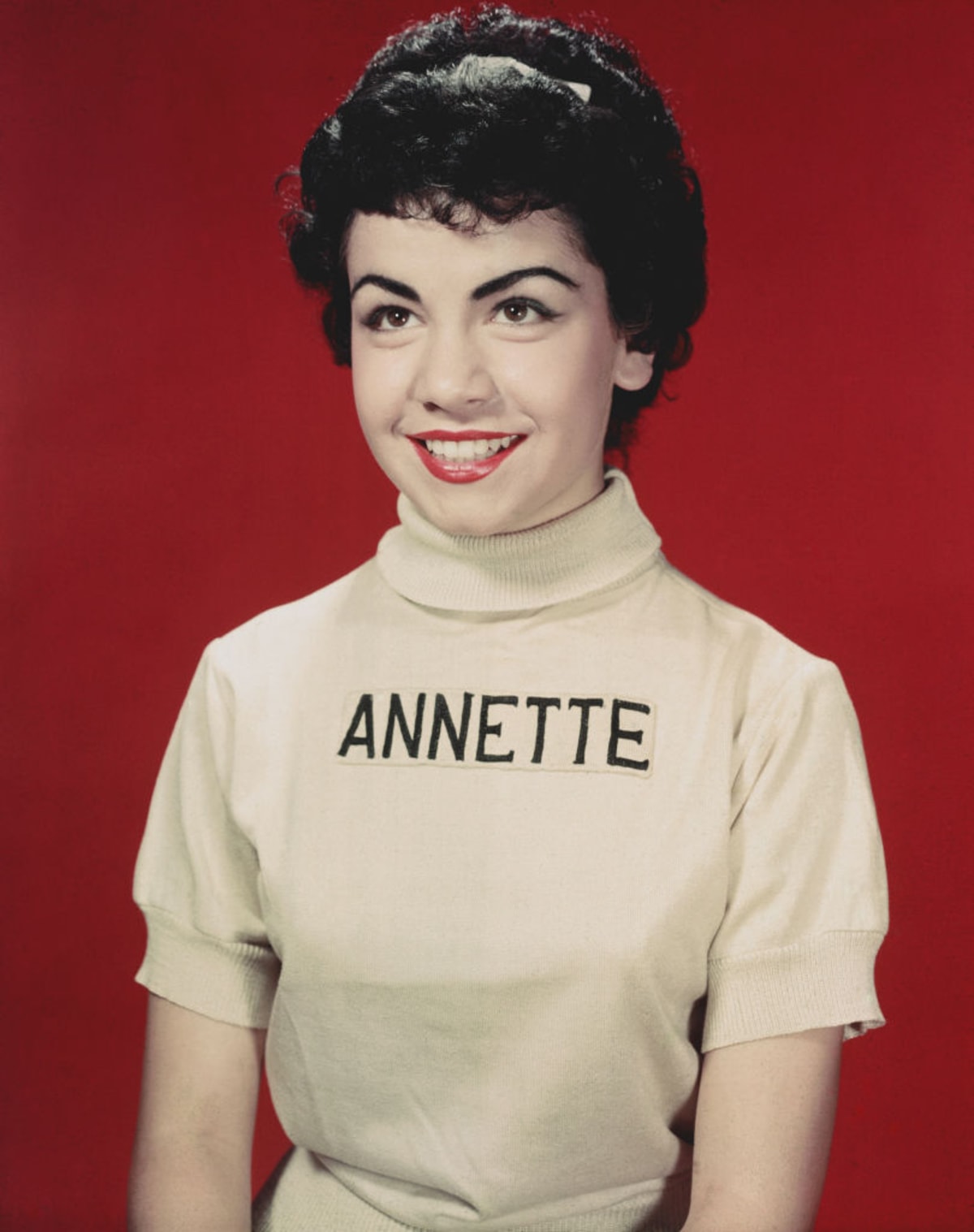 circa 1955: Studio portrait of American actor and Mouseketeer Annette Funicello, child star of the television show 'The Mickey Mouse Club'. Funicello wears her Mousketeer outfit: a white turtleneck with her name on it. (Photo by Hulton Archive/Getty Images)