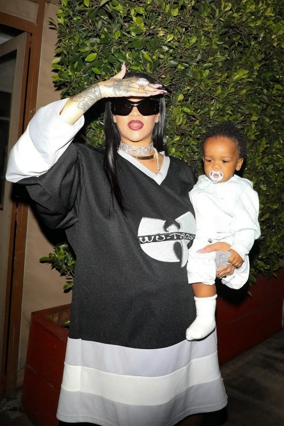 Rihanna added to her statement look with a diamond choker, black sunglasses and peep toe heels (backgrid)