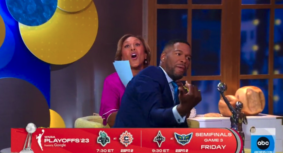 Michael Strahan sat on Robin Roberts' lap unexpectedly on 'GMA' (ABC)