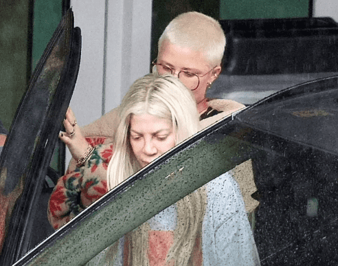 She seemed unsteady and needed help from a friend as she got into her car 