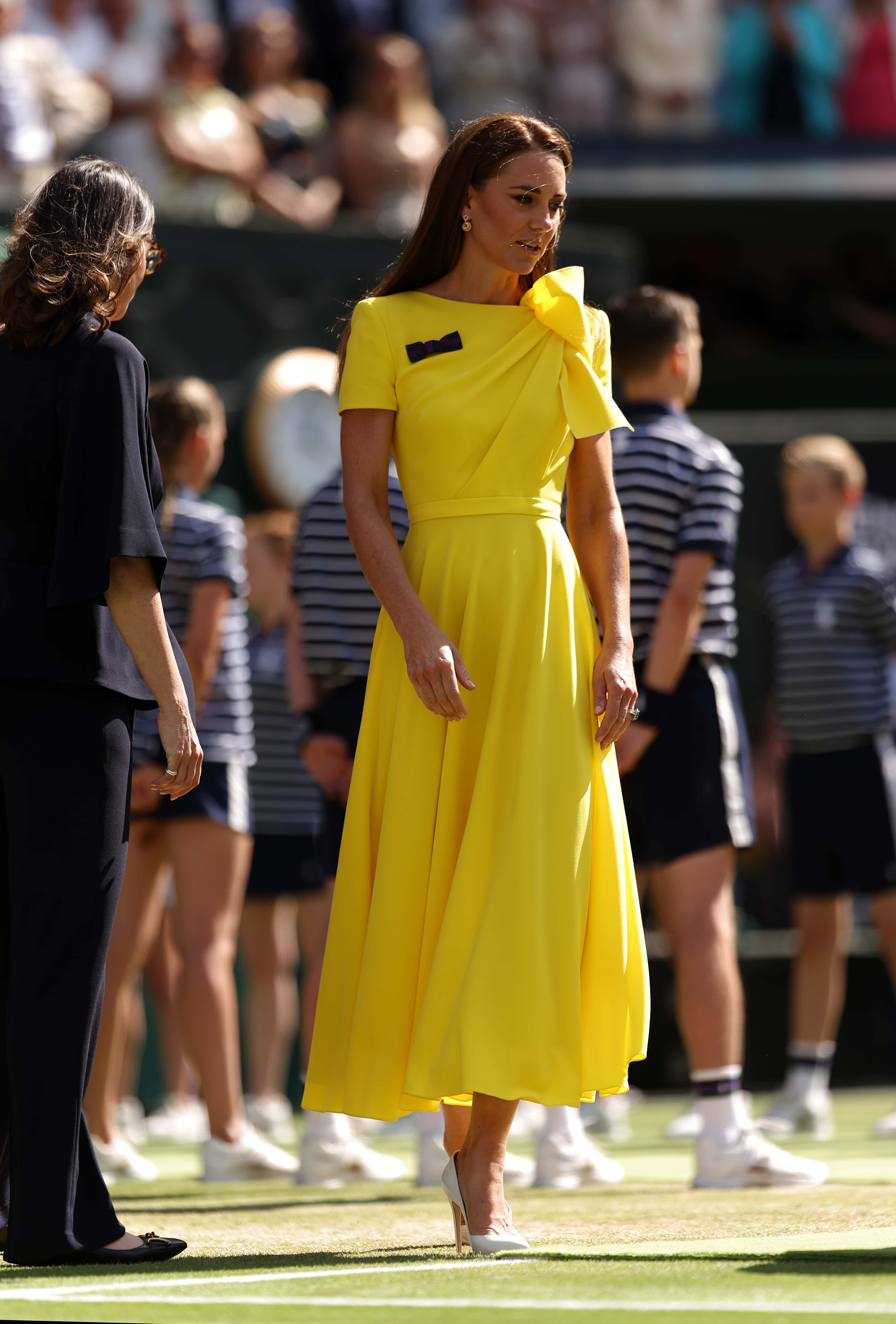 HRH Catherine, The Duchess of Cambridge walks out to present the trophy to Elena Rybakina of Kazakhstan after victory against Ons Jabeur of Tunisia during the Ladies' Singles Final match on day thirteen of The Championships Wimbledon 2022 at All England Lawn Tennis and Croquet Club on July 09, 2022 in London, England.