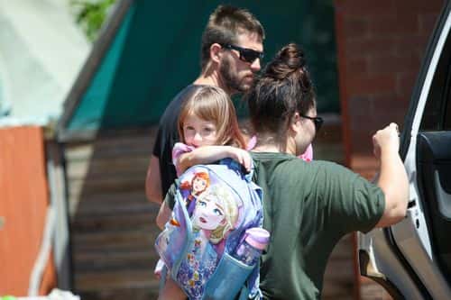 Cleo Smith is carried inside a friend's house by her mother on November 4, 2021 in Carnarvon, Australia. Cleo Smith was found in the early hours Wednesday 3 November after police raided a house in Carnarvon. The four-year-old went missing from the tent she was sharing with her family at the Blowholes campsite near Carnarvon on 16 October. A 36-year-old man is now in custody.