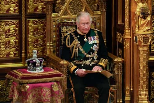 Prince Charles, Prince of Wales reads the Queen's speech next to her Imperial State Crown in the House of Lords Chamber, during the State Opening of Parliament in the House of Lords at the Palace of Westminster on May 10, 2022 in London, England. The State Opening of Parliament formally marks the beginning of the new session of Parliament. It includes Queen's Speech, prepared for her to read from the throne, by her government outlining its plans for new laws being brought forward in the coming parliamentary year. This year the speech will be read by the Prince of Wales as HM The Queen will miss the event due to ongoing mobility issues.