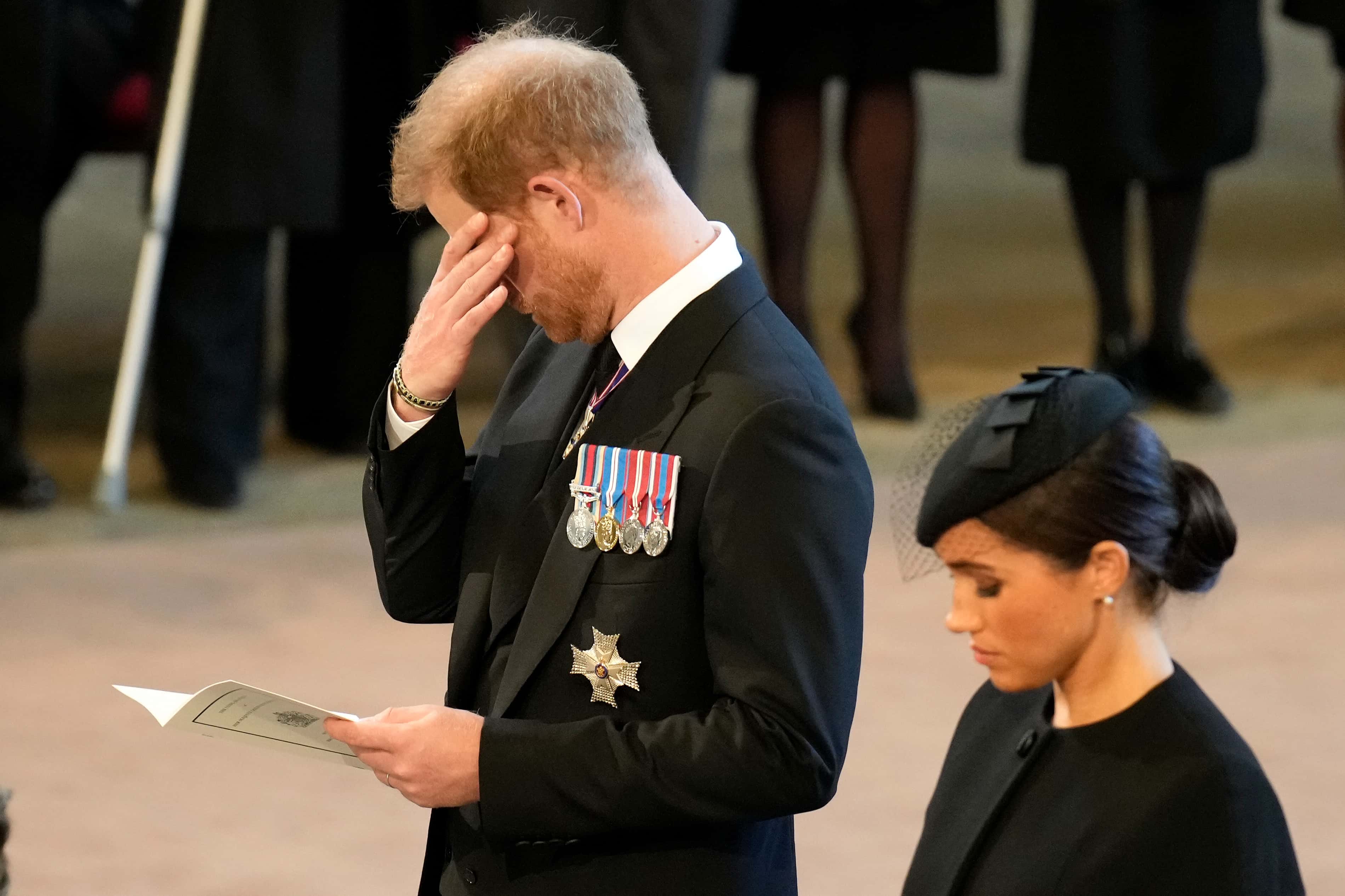 An emotional Prince Harry, Duke of Sussex and Meghan, Duchess of Sussex pay their respects in The Palace of Westminster after the procession for the Lying-in State of Queen Elizabeth II on September 14, 2022 in London, England. Queen Elizabeth II's coffin is taken in procession on a Gun Carriage of The King's Troop Royal Horse Artillery from Buckingham Palace to Westminster Hall where she will lay in state until the early morning of her funeral. Queen Elizabeth II died at Balmoral Castle in Scotland on September 8, 2022, and is succeeded by her eldest son, King Charles III.