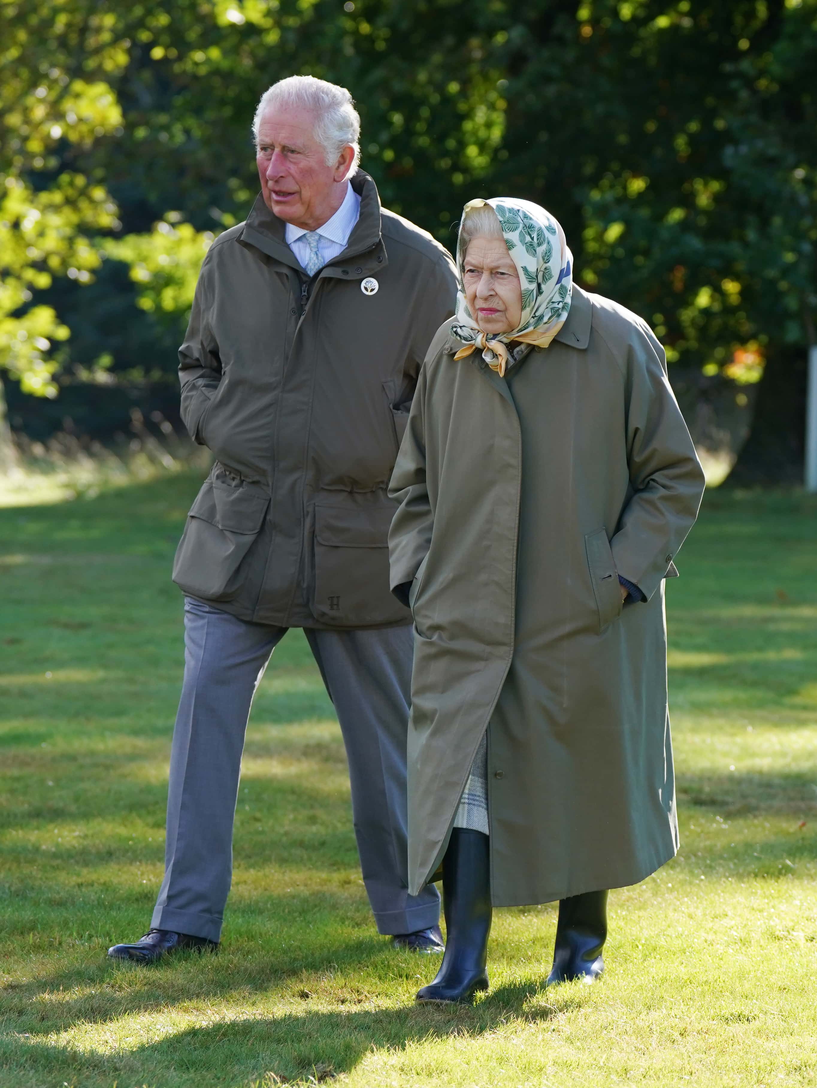 Queen Elizabeth II and Prince Charles, Prince of Wales (known as the Duke of Rothesay when in Scotland) walk to the Balmoral Estate Cricket Pavilion to mark the start of the official planting season for the Queen's Green Canopy (QGC) at the Balmoral Estate on October 1, 2021 near Crathie, Scotland. The QGC is a UK-wide Platinum Jubilee initiative which will create a lasting legacy in tribute to the Queen's 70 years of service to the nation, through a network of trees planted in her name.
