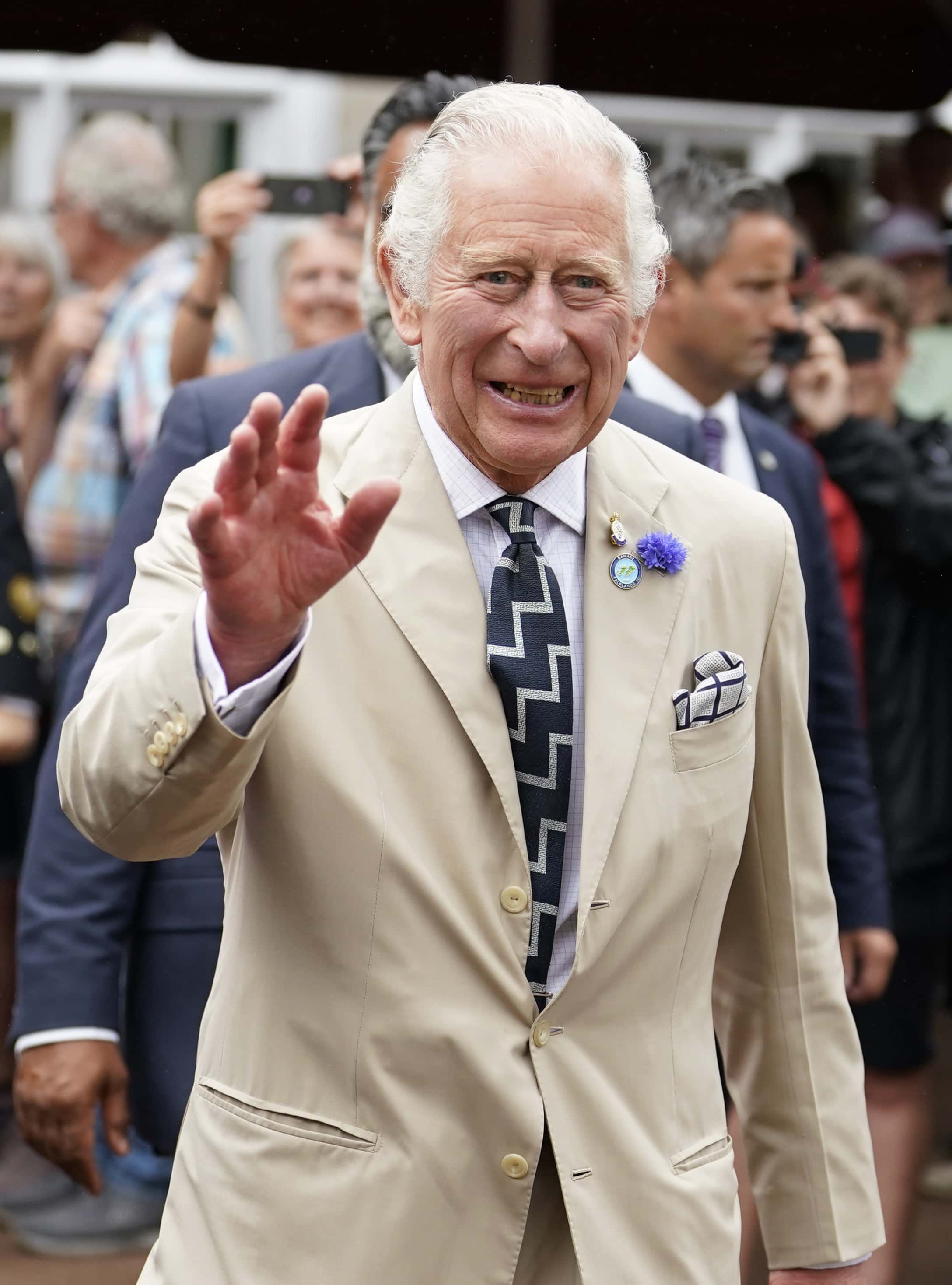 Prince Charles, Prince of Wales waves to members of the public during a visit to Cockington Court, a centre of creativity which is operated by Torbay Coast and Countryside Trust on July 20, 2022 in Torquay, United Kingdom. The Duke and Duchess of Cornwall are on a 3-day visit to the southwestern region to celebrate the Prince of Wales' 70th year as the Duke of Cornwall.
