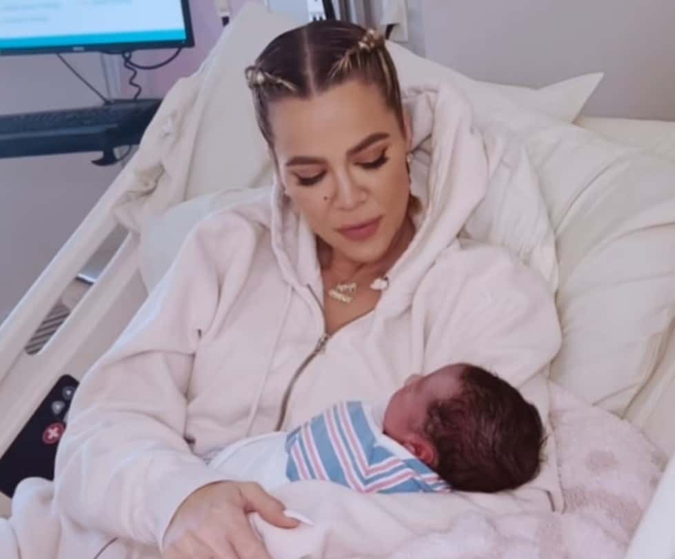 Khloe Kardashian can be seen cradling her newborn son (Screenshot/Hulu)