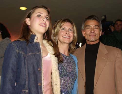 Actress Olivia Newton John, center, daughter Chloe, left, and boyfriend Patrick McDermott, right, arrive at the Los Angeles opening of