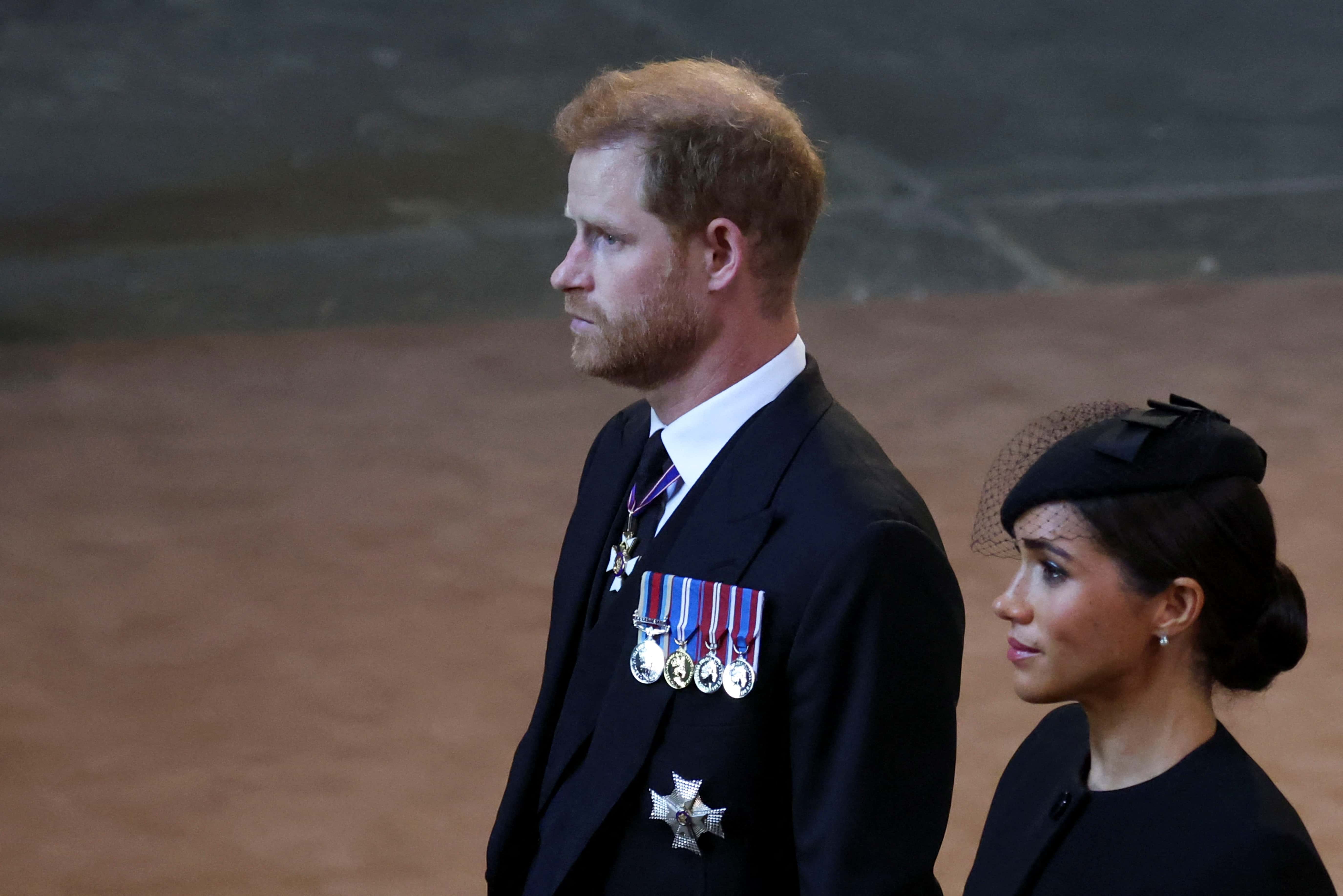 Prince Harry and Meghan, Duchess of Sussex walk as procession with the coffin of Britain's Queen Elizabeth arrives at Westminster Hall from Buckingham Palace for her lying in state on September 14, 2022 in London, United Kingdom. Queen Elizabeth II's coffin is taken in procession on a Gun Carriage of The King's Troop Royal Horse Artillery from Buckingham Palace to Westminster Hall where she will lay in state until the early morning of her funeral. Queen Elizabeth II died at Balmoral Castle in Scotland on September 8, 2022, and is succeeded by her eldest son, King Charles III.