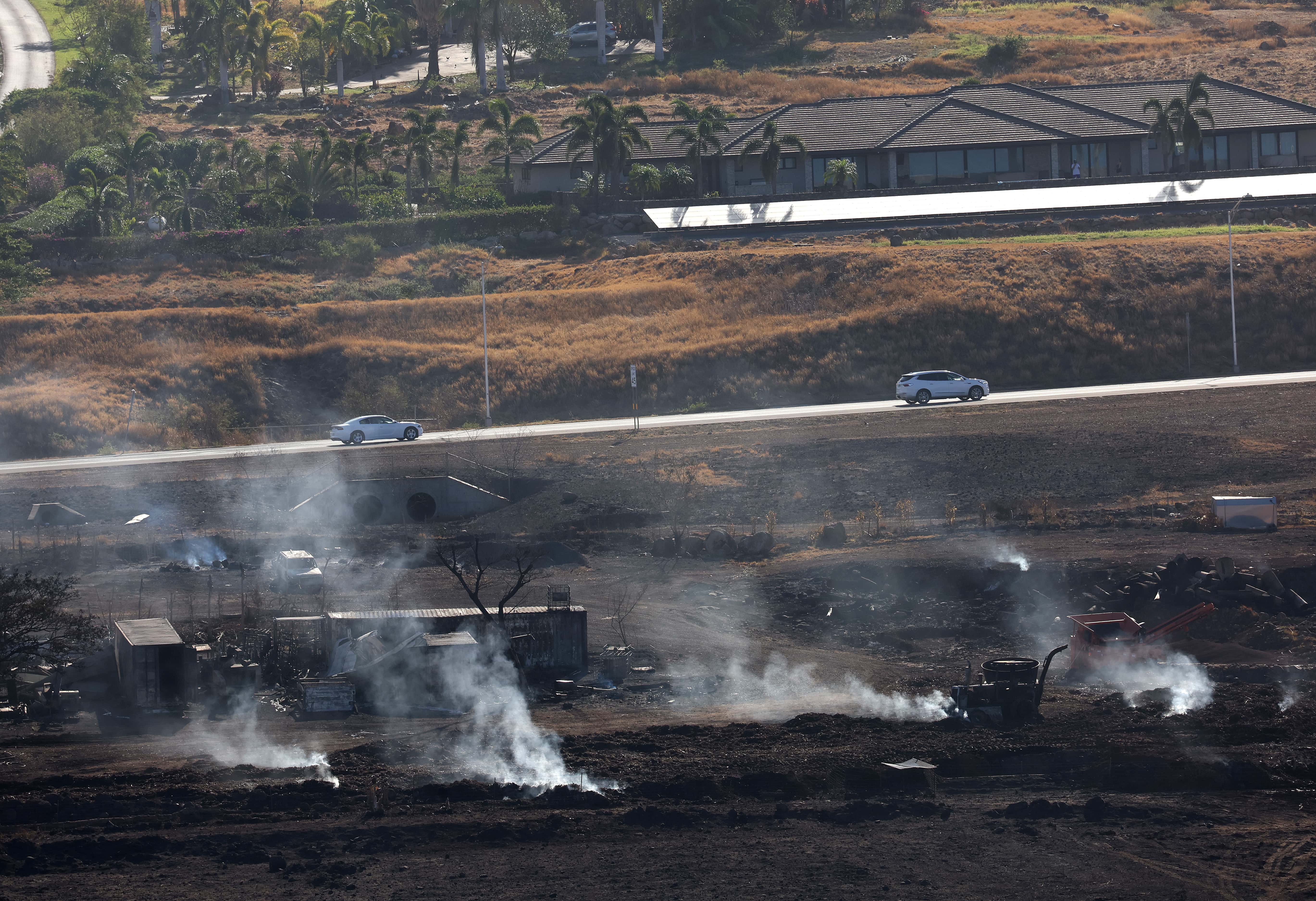 In an aerial view, hot spots continue to smolder near a neighborhood destroyed by a wildfire on August 11, 2023, in Lahaina, Hawaii. Dozens of people were killed and thousands were displaced after a wind-driven wildfire devastated the town of Lahaina on Tuesday. Crews are continuing to search for missing people. (Photo by Justin Sullivan/Getty Images)