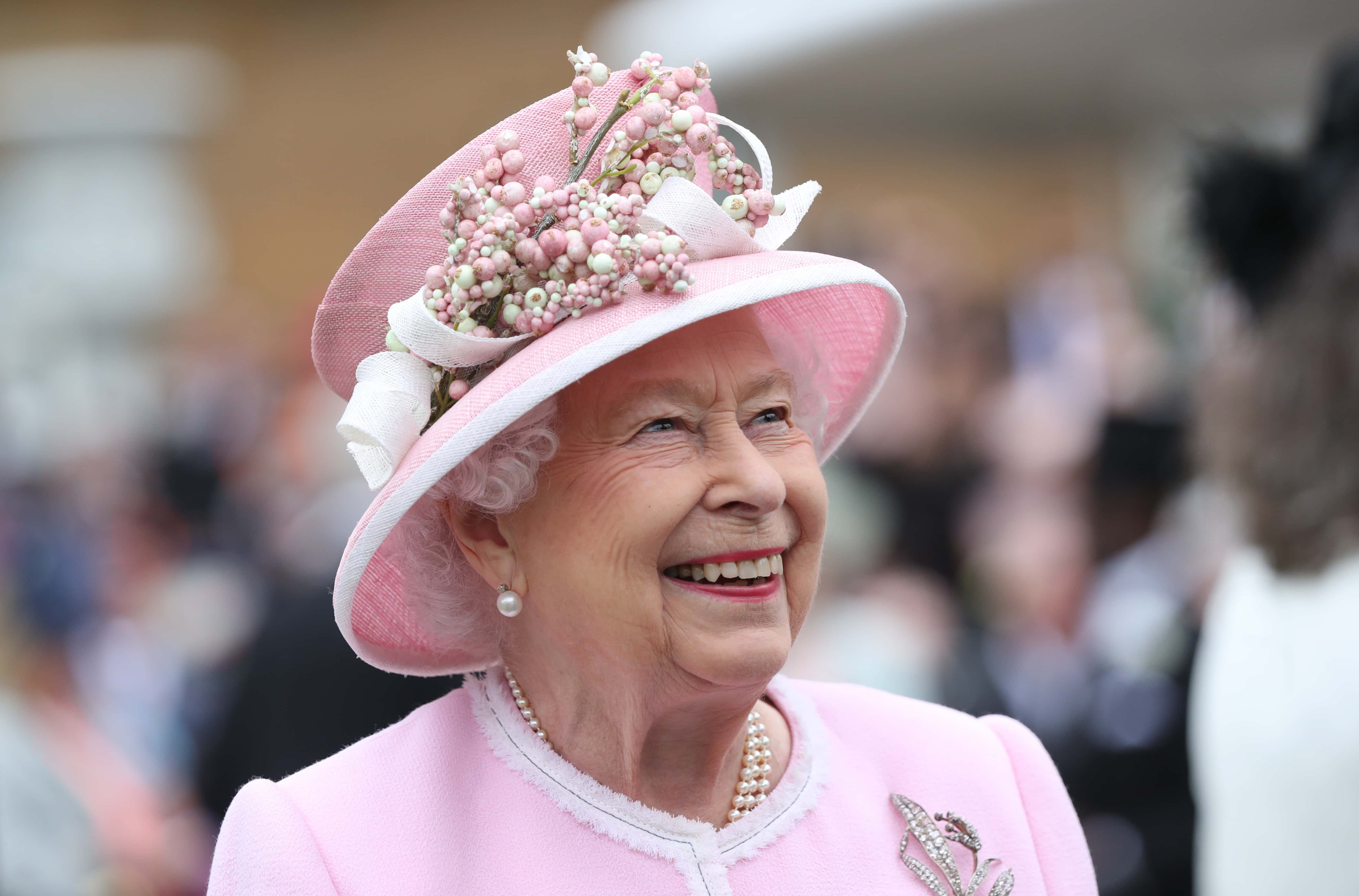 Queen Elizabeth II meets guests as she attends the Royal Garden Party at Buckingham Palace on May 29, 2019 in London, England.