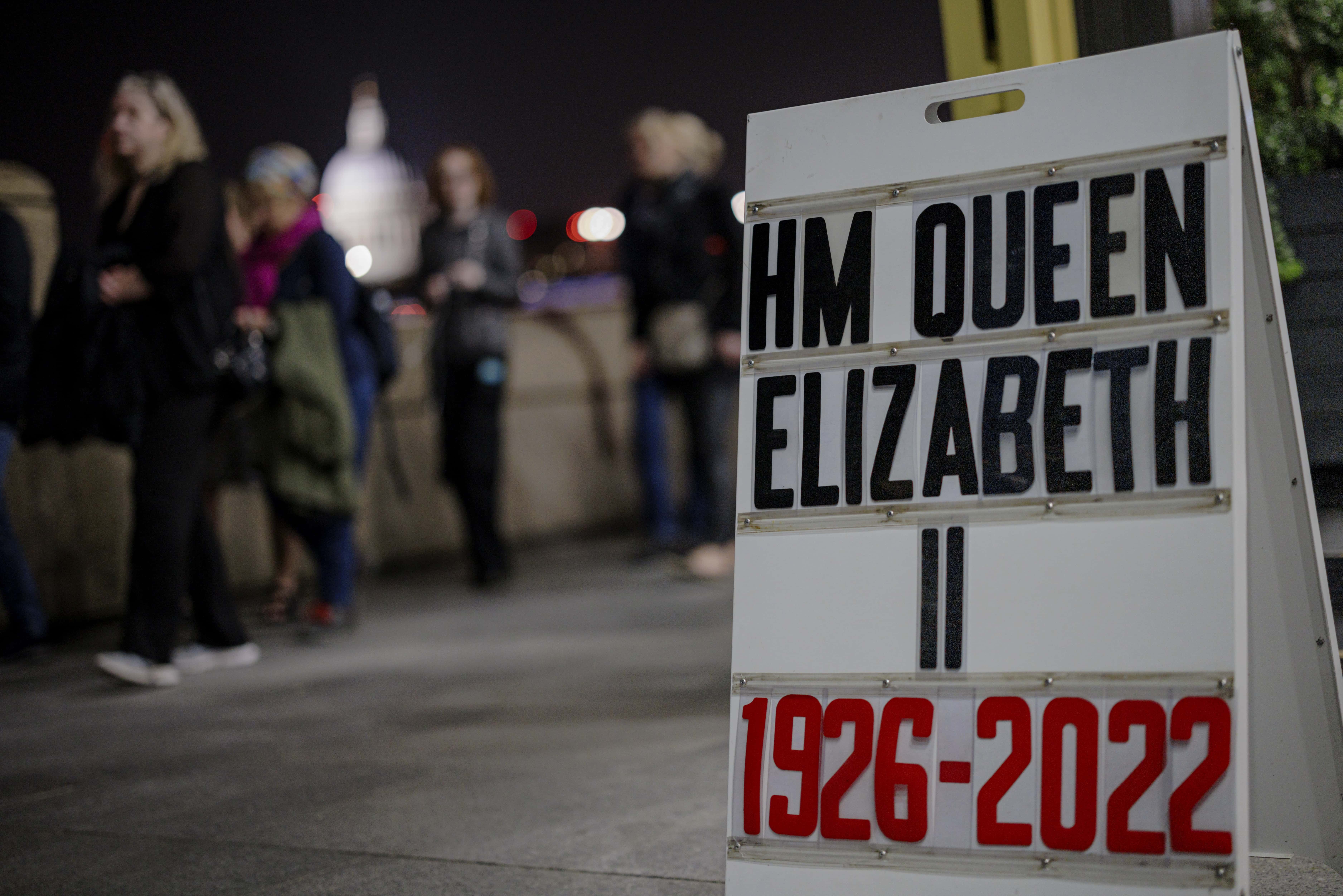 A sandwich board displaying the years of Queen Elizabeth II's life is seen on Southbank as tens of thousands join queues to see Queen Elizabeth II lying in state at Westminster Hall on September 14, 2022 in London, England. Elizabeth Alexandra Mary Windsor was born in Bruton Street, Mayfair, London on 21 April 1926. She married Prince Philip in 1947 and acceded to the throne of the United Kingdom and Commonwealth on 6 February 1952 after the death of her Father, King George VI. Queen Elizabeth II died at Balmoral Castle in Scotland on September 8, 2022, and is succeeded by her eldest son, King Charles III. (Photo by Rob Pinney/Getty Images)