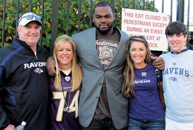 Michael was adopted by the Sean (left) and Leigh Ann Tuohy (second left) and raised with their children Collins (second right) and Sean Jr. (right) (Handout)
