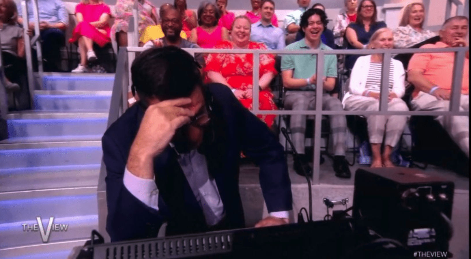 'The View' producer Bryan who was standing off stage had to hide his face after Whoopi called him out (Hulu)