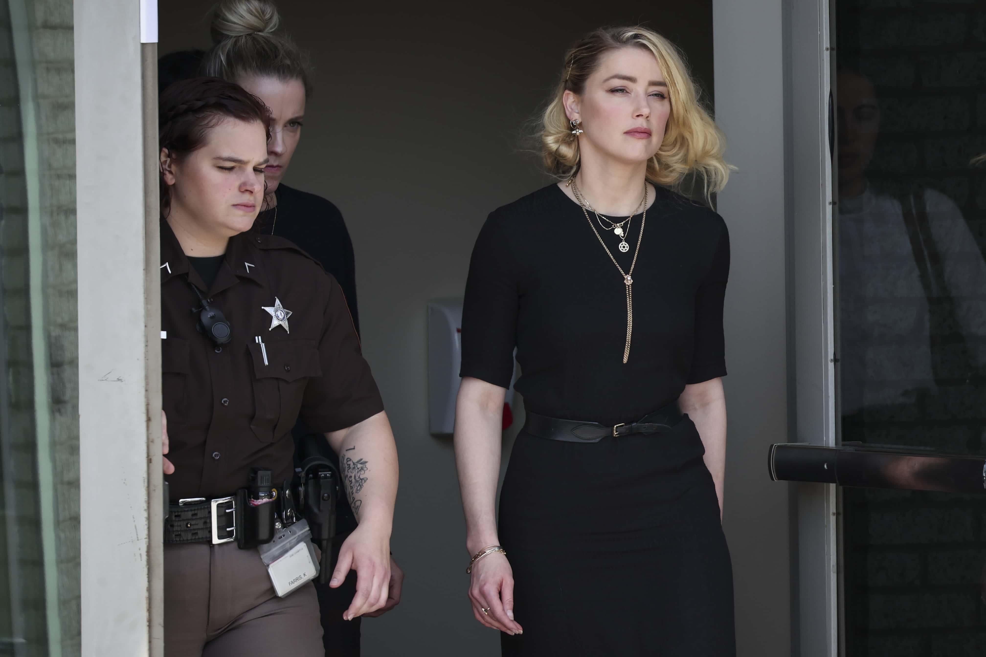 Actress Amber Heard (R) departs the Fairfax County Courthouse on June 1, 2022 in Fairfax, Virginia. The jury in the Depp vs. Heard case awarded actor Johnny Depp $15 million in his defamation case against Heard.