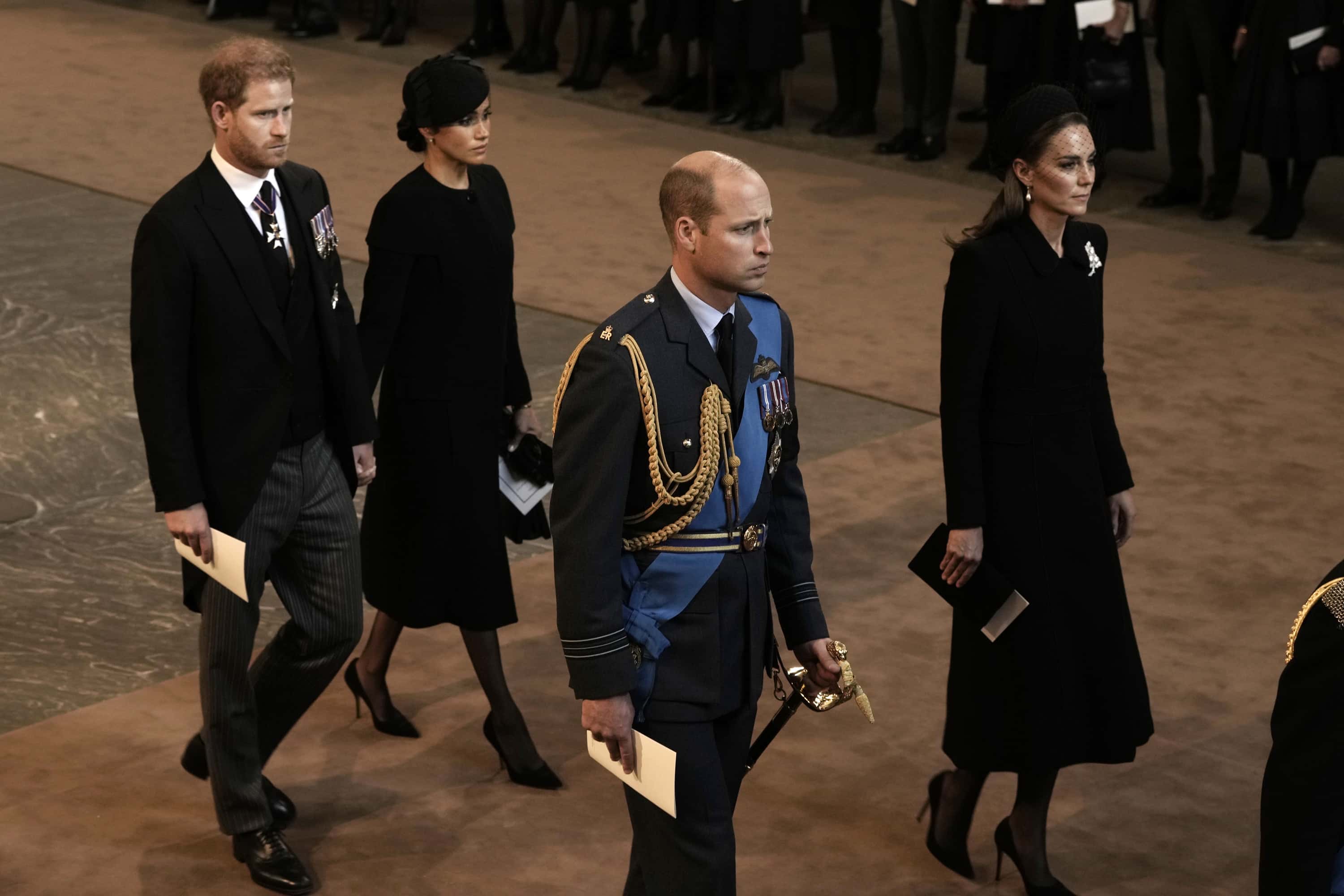Prince Harry, Duke of Sussex and Meghan, Duchess of Sussex, Prince William, Prince of Wales and Catherine, Princess of Wales walk behind the coffin as they arrive in The Palace of Westminster after the procession for the Lying-in State of Queen Elizabeth II on September 14, 2022 in London, England. Queen Elizabeth II's coffin is taken in procession on a Gun Carriage of The King's Troop Royal Horse Artillery from Buckingham Palace to Westminster Hall where she will lay in state until the early morning of her funeral. Queen Elizabeth II died at Balmoral Castle in Scotland on September 8, 2022, and is succeeded by her eldest son, King Charles III.