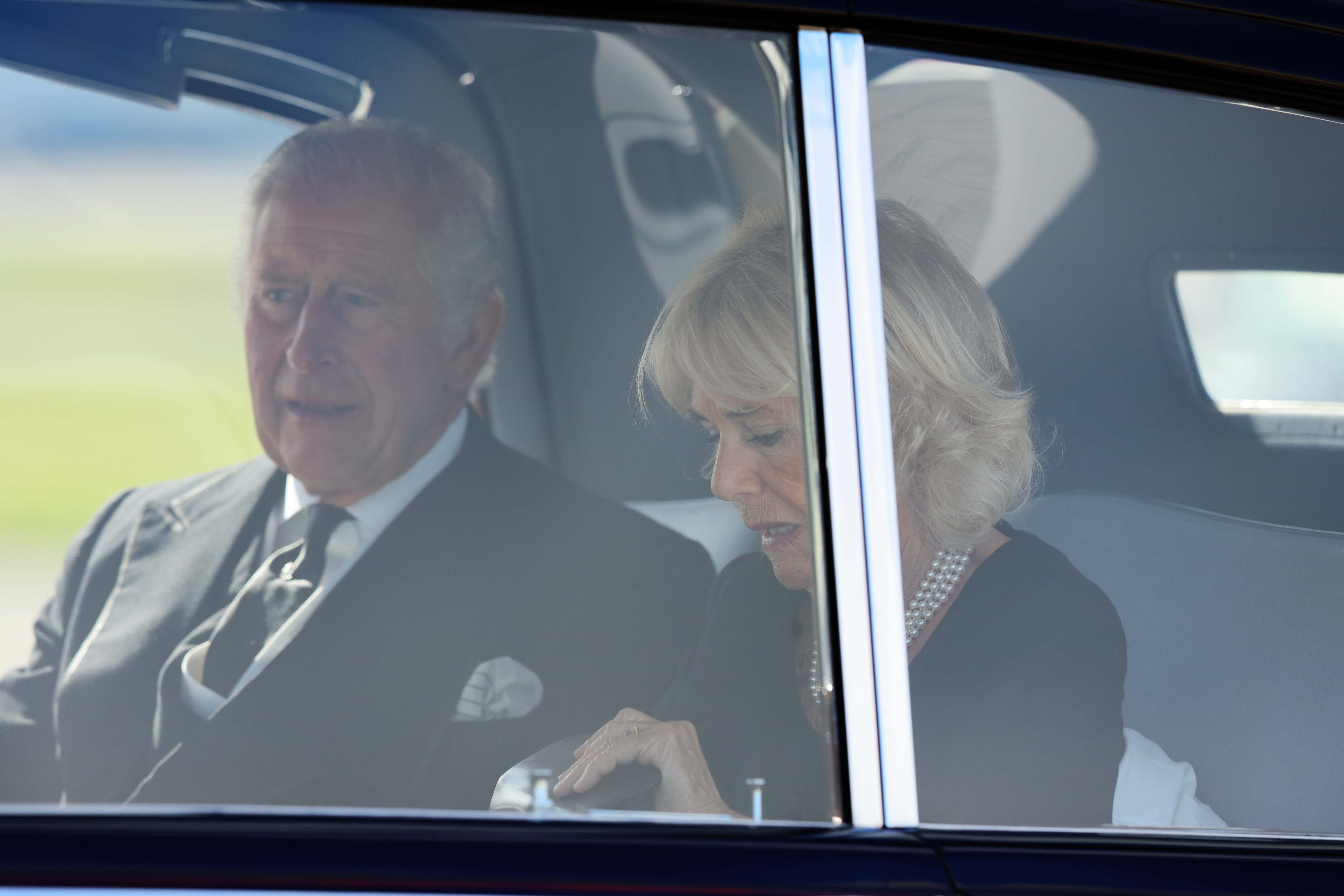 King Charles III and Camilla, Queen Consort leave Edinburgh Airport in a State Car on their way to Holyroodhouse on September 12, 2022 in Edinburgh, Scotland. King Charles III joins the procession accompanying Her Majesty The Queen's coffin from the Palace of Holyroodhouse along the Royal Mile to St Giles Cathedral. The King and The Queen Consort, accompanied by other Members of the Royal Family also attend a Service of Prayer and Reflection for the Life of The Queen where it lies in rest for 24 hours before being transferred by air to London.