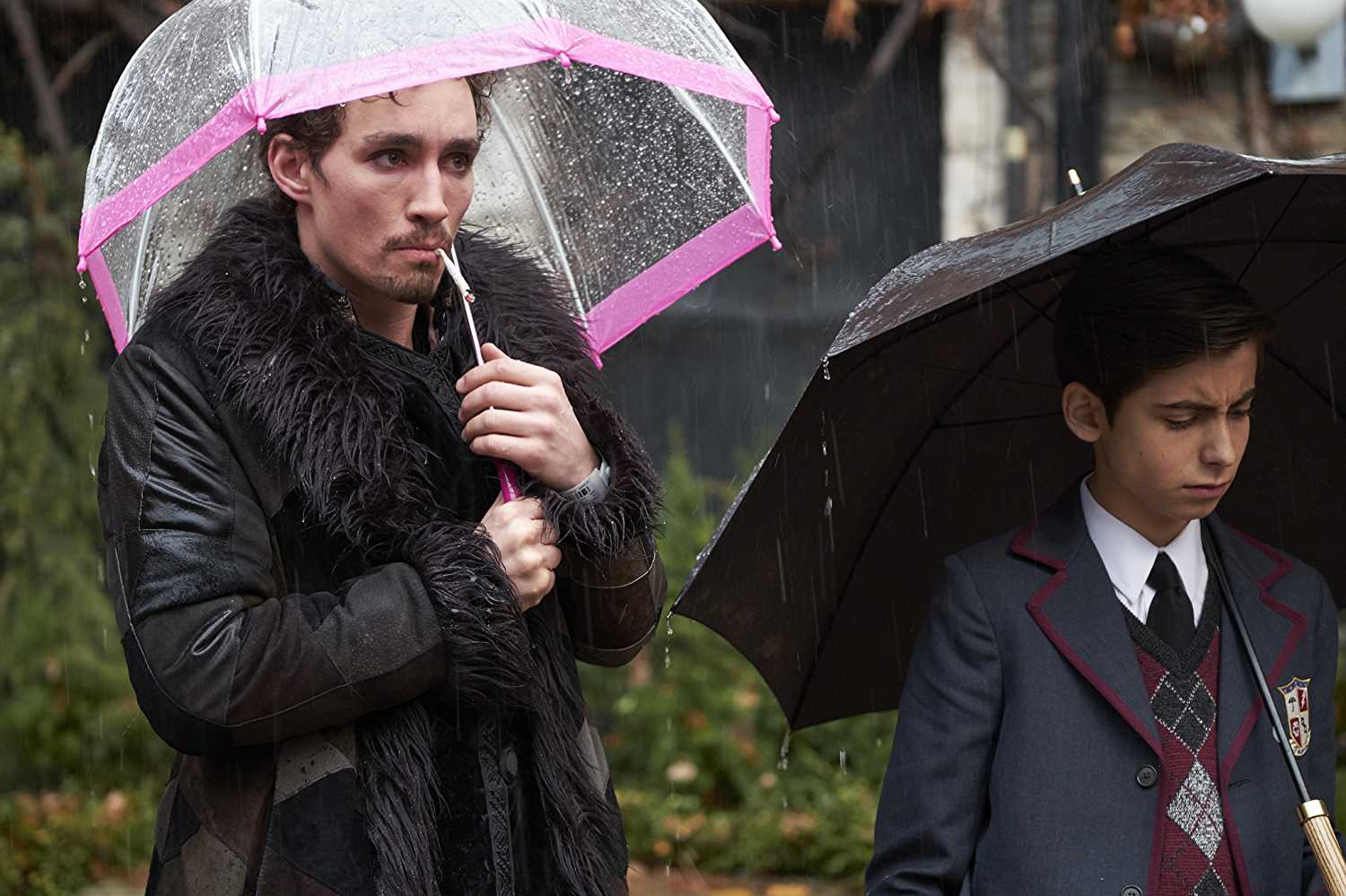 Robert Sheehan (Klaus Hargreeves) and Aidan Gallagher (Number 5) in 'The Umbrella Academy'. (Source: IMDB)