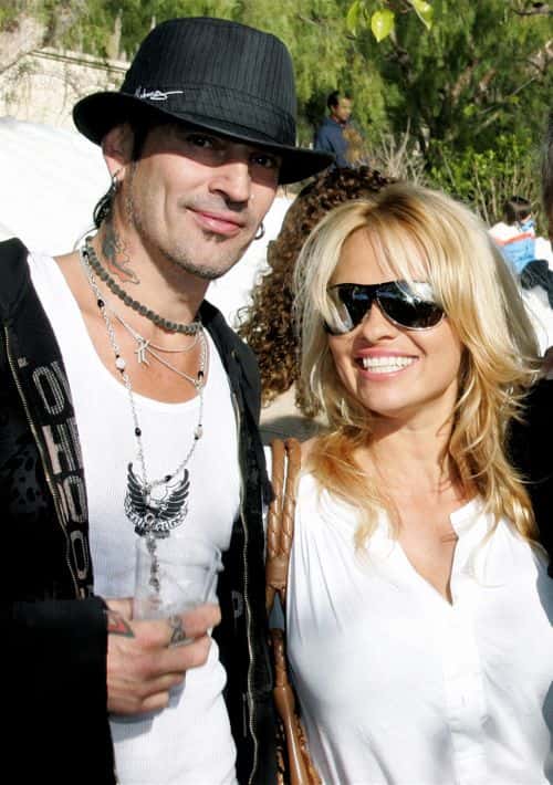(US TABS AND HOLLYWOOD REPORTER OUT) Musician Tommy Lee and actress Pamela Anderson pose at the home of John Paul DeJoria, CEO and co-founder of John Paul Mitchell Haircare Systems, during his annual party to thank movie, television and music star friends and his co-workers for their charitable work on December 24, 2005 in Malibu, California.