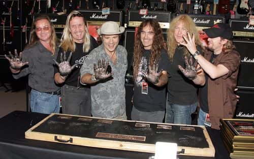 Rock band Iron Maiden members (L-R) Dave Murray, Nicko McBrain, Bruce Dickinson, Steve Harris, Janick Gers and Adrian Smith pose for a photograph as they are inducted Into Hollywood's Rock Walk, at the Guitar Center on August 19, 2005 in Hollywood, Los Angeles, California.