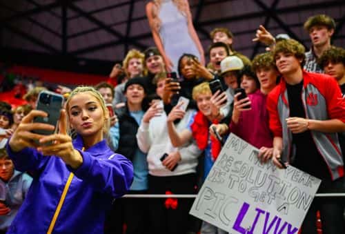 Olivia Dunne of LSU takes a 'selfie' with fans after a PAC-12 meet against Utah at Jon M. Huntsman Center on January 06, 2023 in Salt Lake City, Utah.