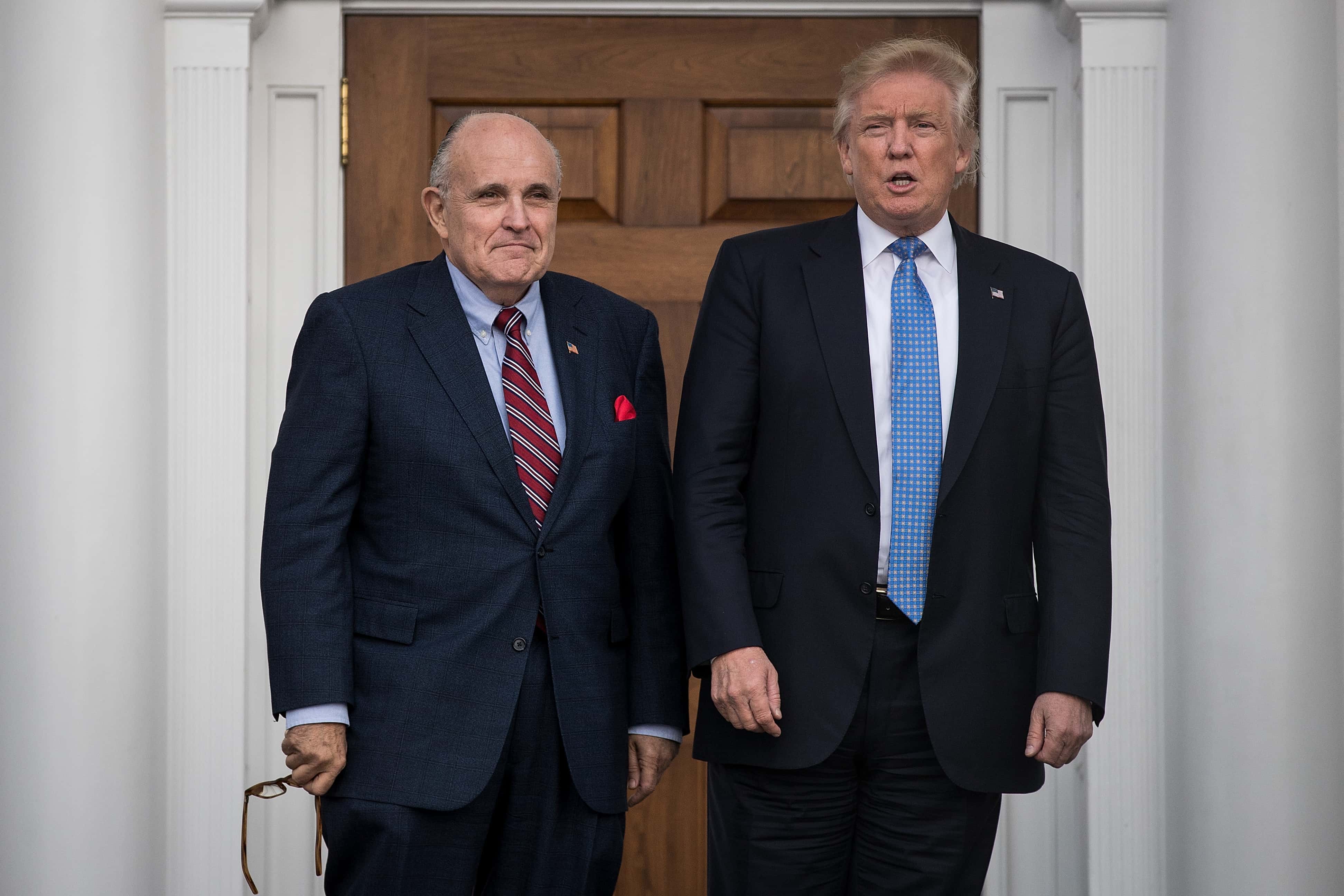 (L to R) Former New York City mayor Rudy Giuliani stands with president-elect Donald Trump before their meeting at Trump International Golf Club, November 20, 2016 in Bedminster Township, New Jersey. Trump and his transition team are in the process of filling cabinet and other high level positions for the new administration.