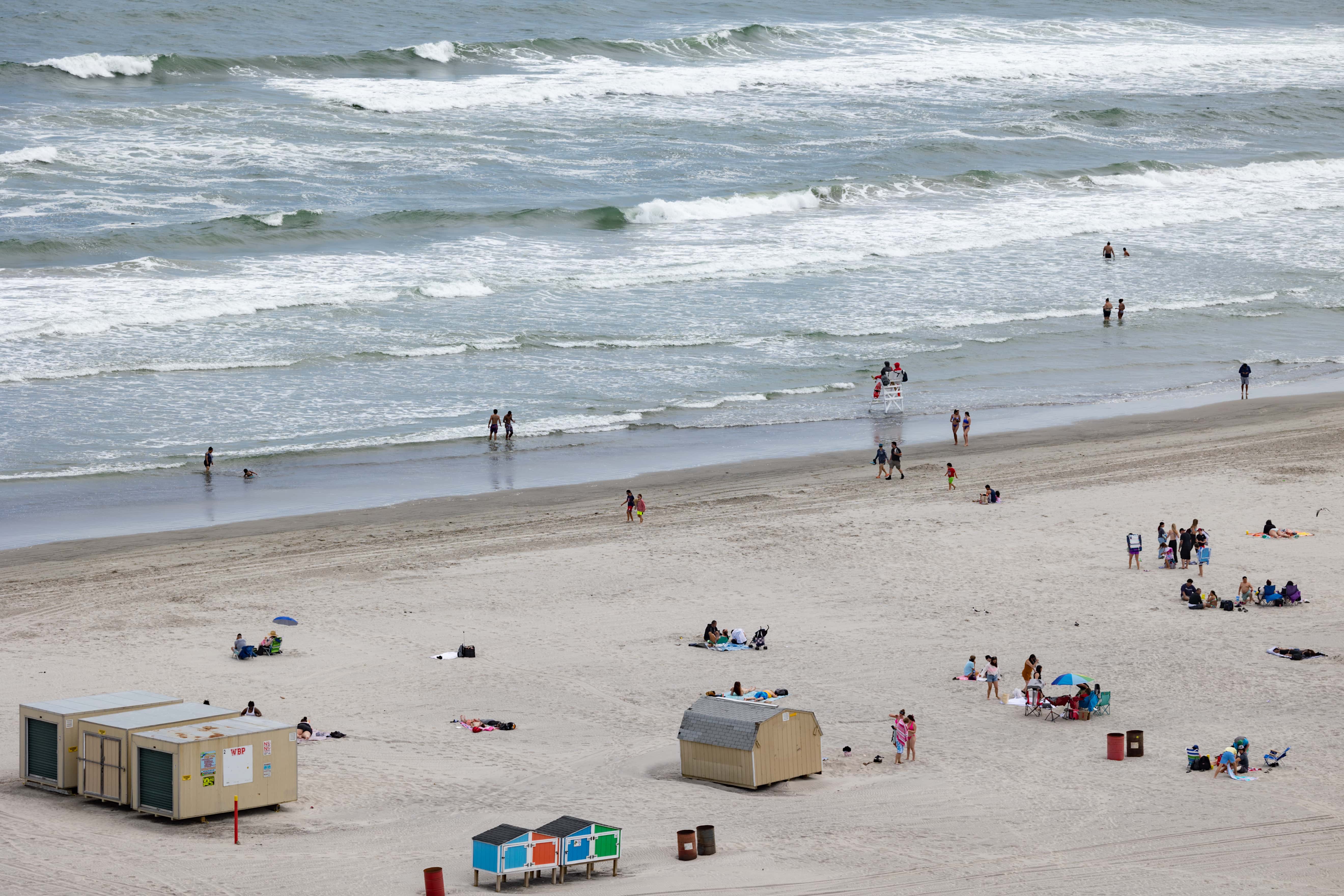 People spend time on the beach during the Memorial Day weekend on May 28, 2023, in Wildwood, New Jersey. Memorial Day weekend kicks off the start of the beach season on the East Coast. (Photo by Hannah Beier/Getty Images)