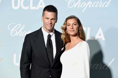 Gisele Bündchen poses with husbnad Tom Brady in 2019 (Photo by Kevin Winter/ Getty Images)