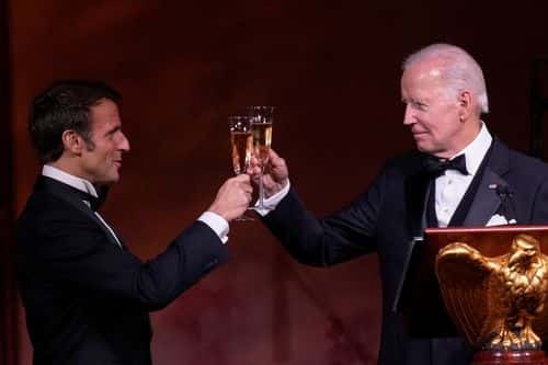 U.S. President Joe Biden and French President Emmanuel Macron toast their glasses after speaking at the state dinner on the South Lawn of the White House on December 1, 2022 in Washington, DC. President Biden is hosting Macron for the first official state visit of the Biden administration. (Photo by Drew Angerer/Getty Images)