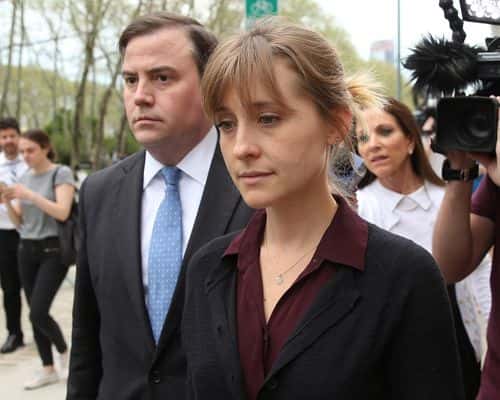 Actress Allison Mack (R) departs the United States Eastern District Court after a bail hearing in relation to the sex trafficking charges filed against her on May 4, 2018 in the Brooklyn borough of New York City. The actress known for her role on 'Smallville' is charged with sex trafficking. Along with alleged cult leader Keith Raniere, prosecutors say Mack recruited women to a upstate New york mentorship group NXIVM that turned them into sex slaves.