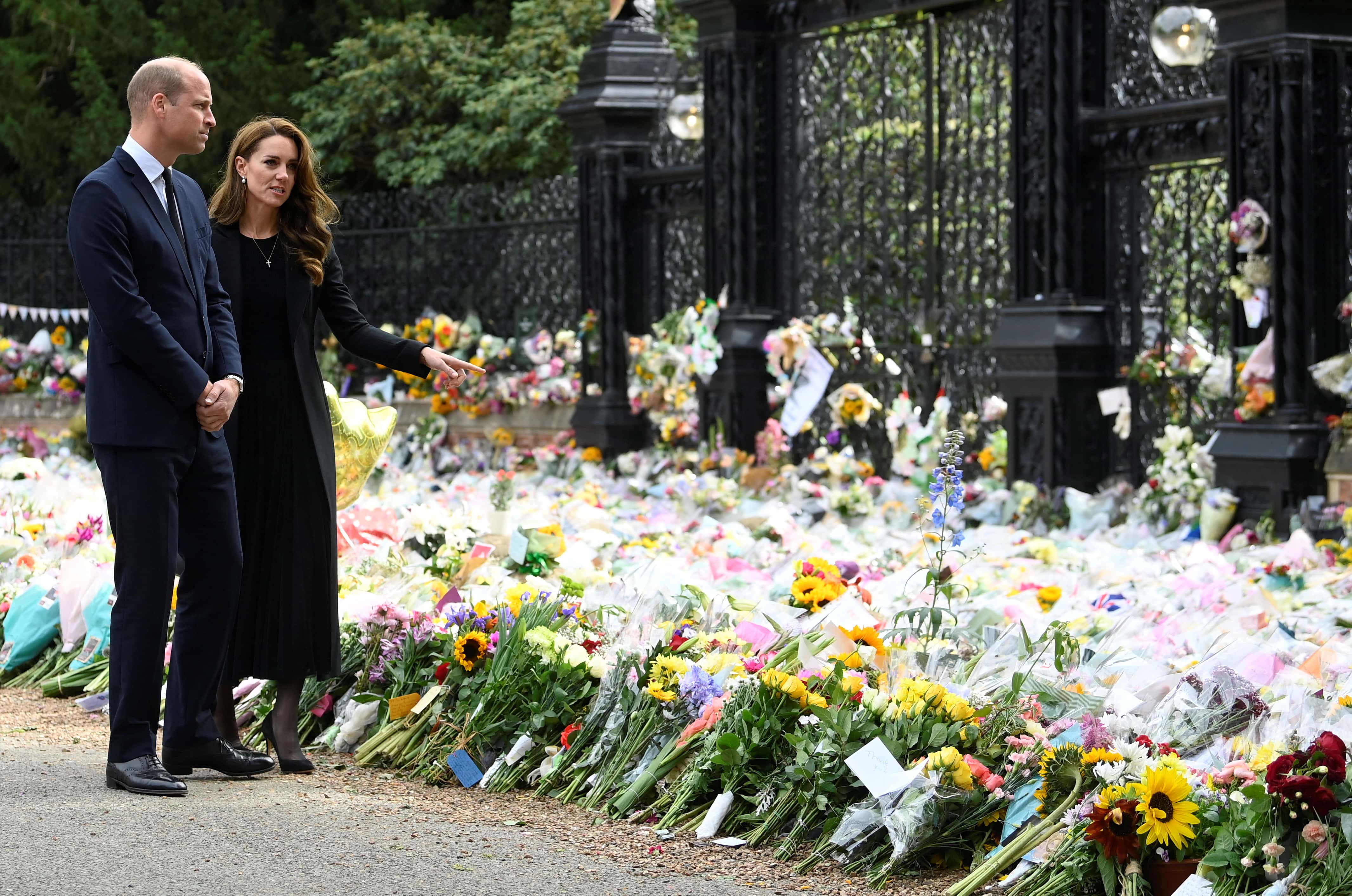 William, Prince of Wales and Catherine, Princess of Wales, look at floral tributes, following the death of Britain's Queen Elizabeth, at Sandringham Estate on September 15, 2022 in Sandringham, England.