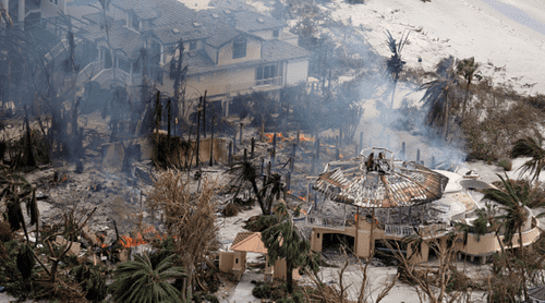 In this aerial view, a home burns after Hurricane Ian passed through the area on September 29, 2022 in Sanibel, Florida. The hurricane brought high winds, storm surge and rain to the area causing severe damage (Photo by Joe Raedle/Getty Images)