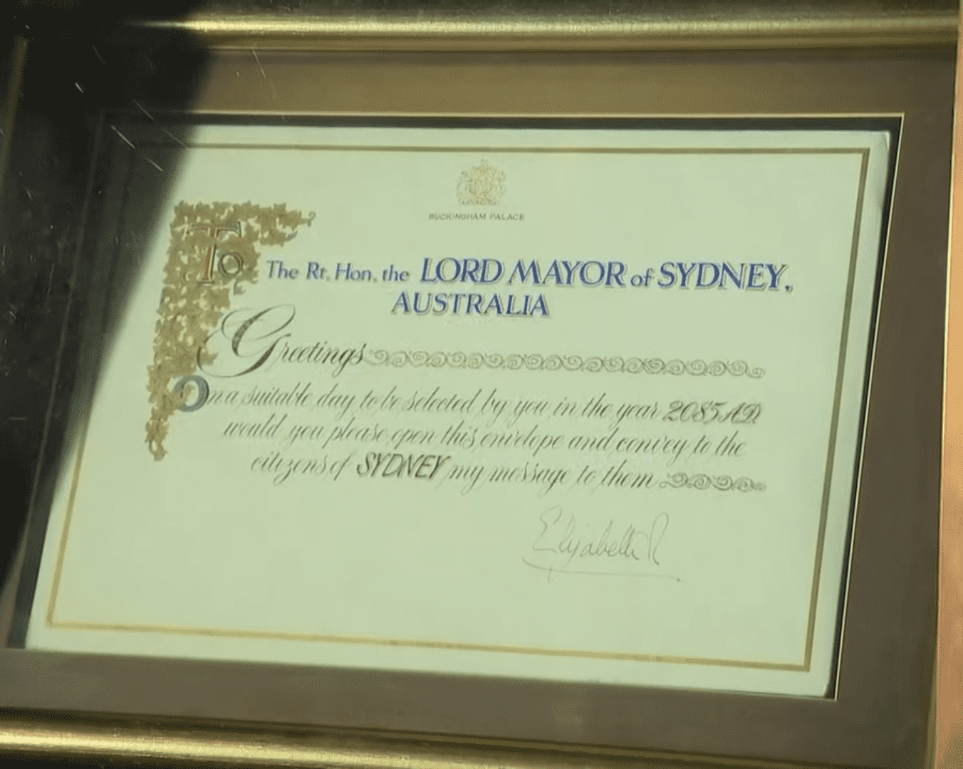 The letter sits framed inside a glass case in the restricted dome area in the top of the QVB with only Her Majesty's instructions visible (YouTube/ 9 News Australia)
