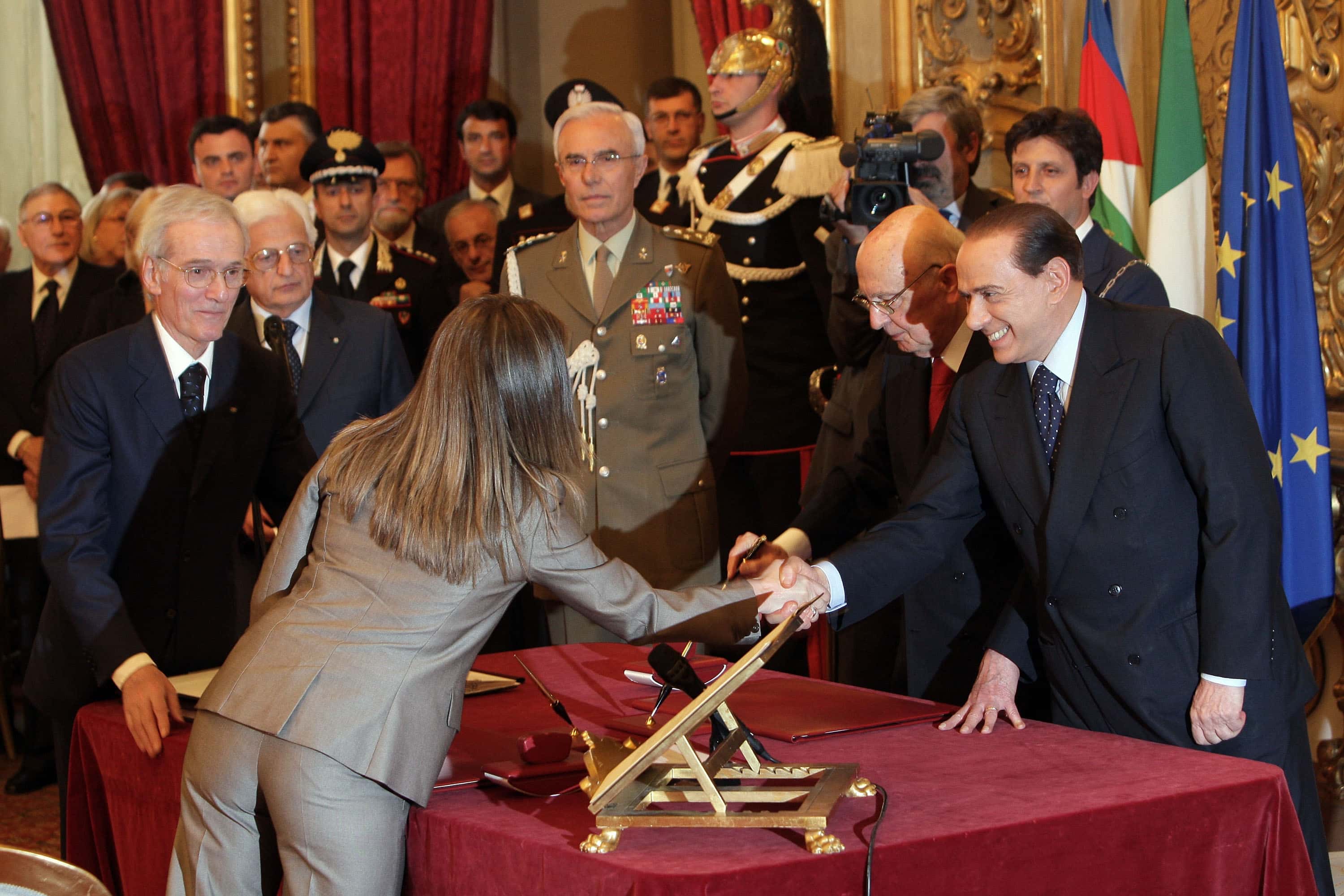 Newly appointed minister Giorgia Meloni, 30, (Youth Policies) (L) receives congratulations from Silvio Berlusconi at the end of the swearing in ceremony for the new Berlusconi government at the Quirinale Palace on May 8, 2008 in Rome, Italy. After being ushered back into power by forming a strong conservative coalition, the media magnate presented his third government. She is the youngest minister in the government.