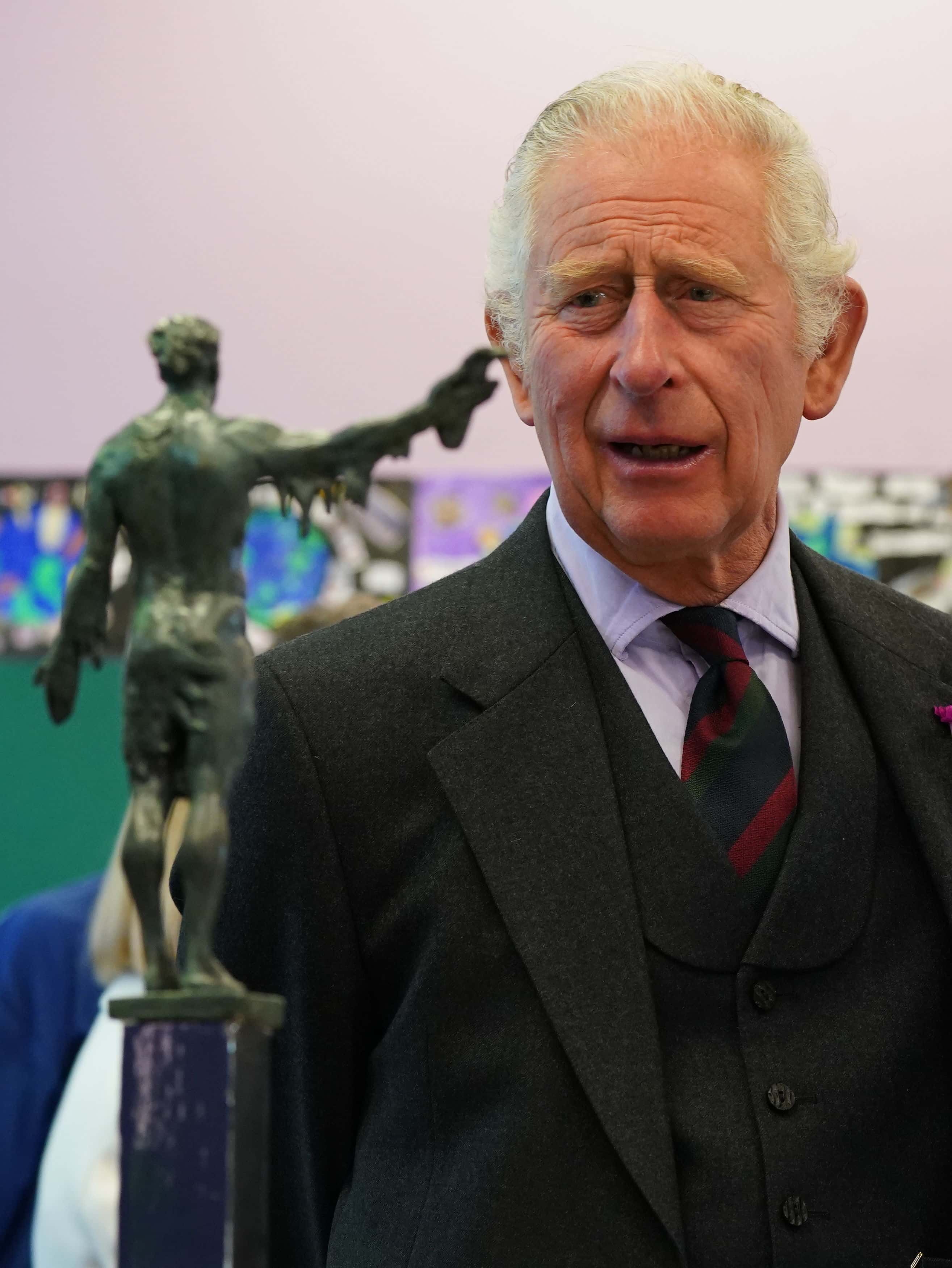 The Prince of Wales, known as the Duke of Rothesay when in Scotland, views a model of a memorial by the Seafarers Memorial Group on July 29, 2022 in Wick, Scotland.