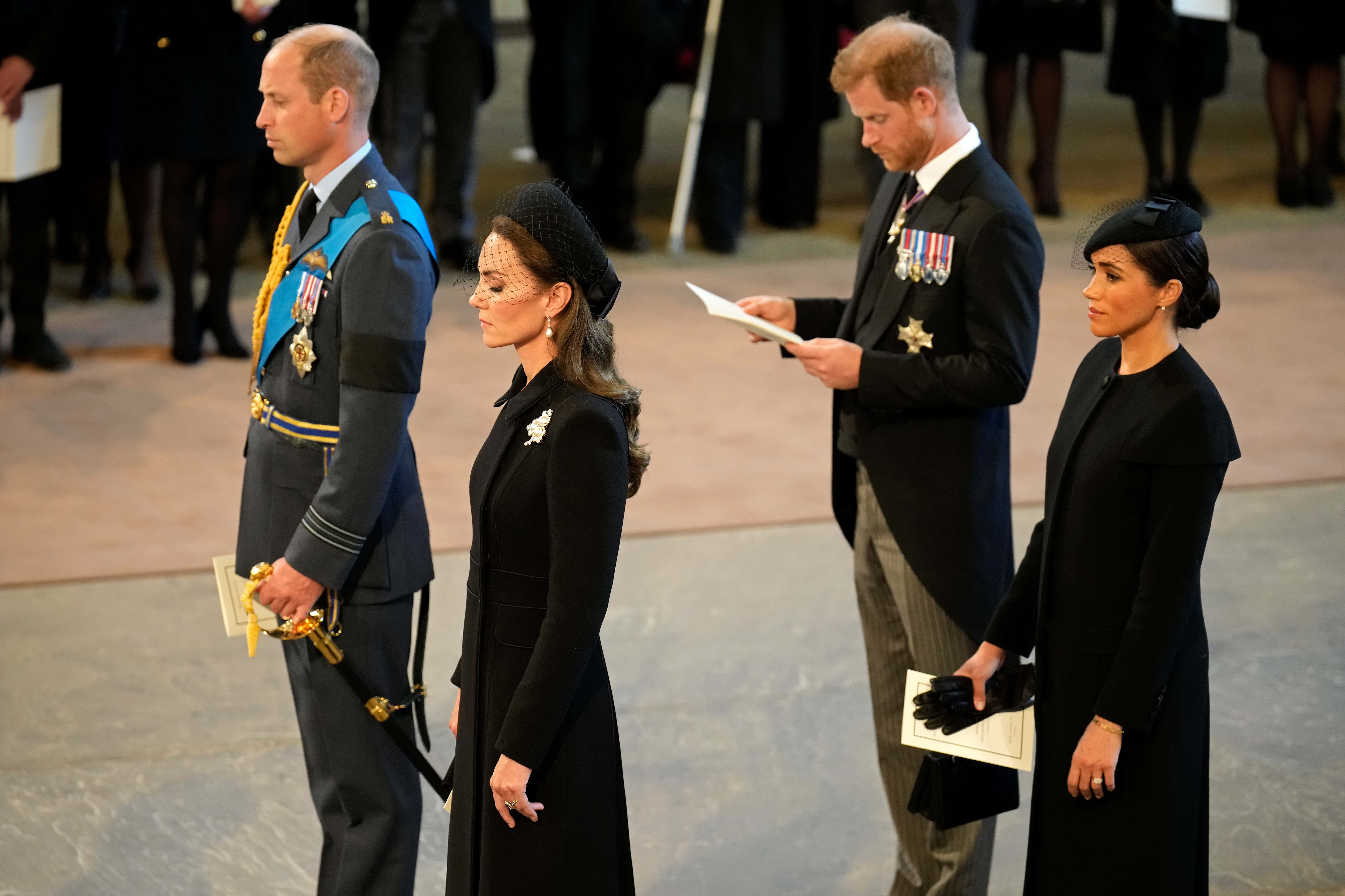 Prince William, Prince of Wales, Catherine, Princess of Wales, Prince Harry, Duke of Sussex and Meghan, Duchess of Sussex seen inside the Palace of Westminster during the Lying-in State of Queen Elizabeth II on September 14, 2022 in London, England. Queen Elizabeth II's coffin is taken in procession on a Gun Carriage of The King's Troop Royal Horse Artillery from Buckingham Palace to Westminster Hall where she will lay in state until the early morning of her funeral. Queen Elizabeth II died at Balmoral Castle in Scotland on September 8, 2022, and is succeeded by her eldest son, King Charles III.