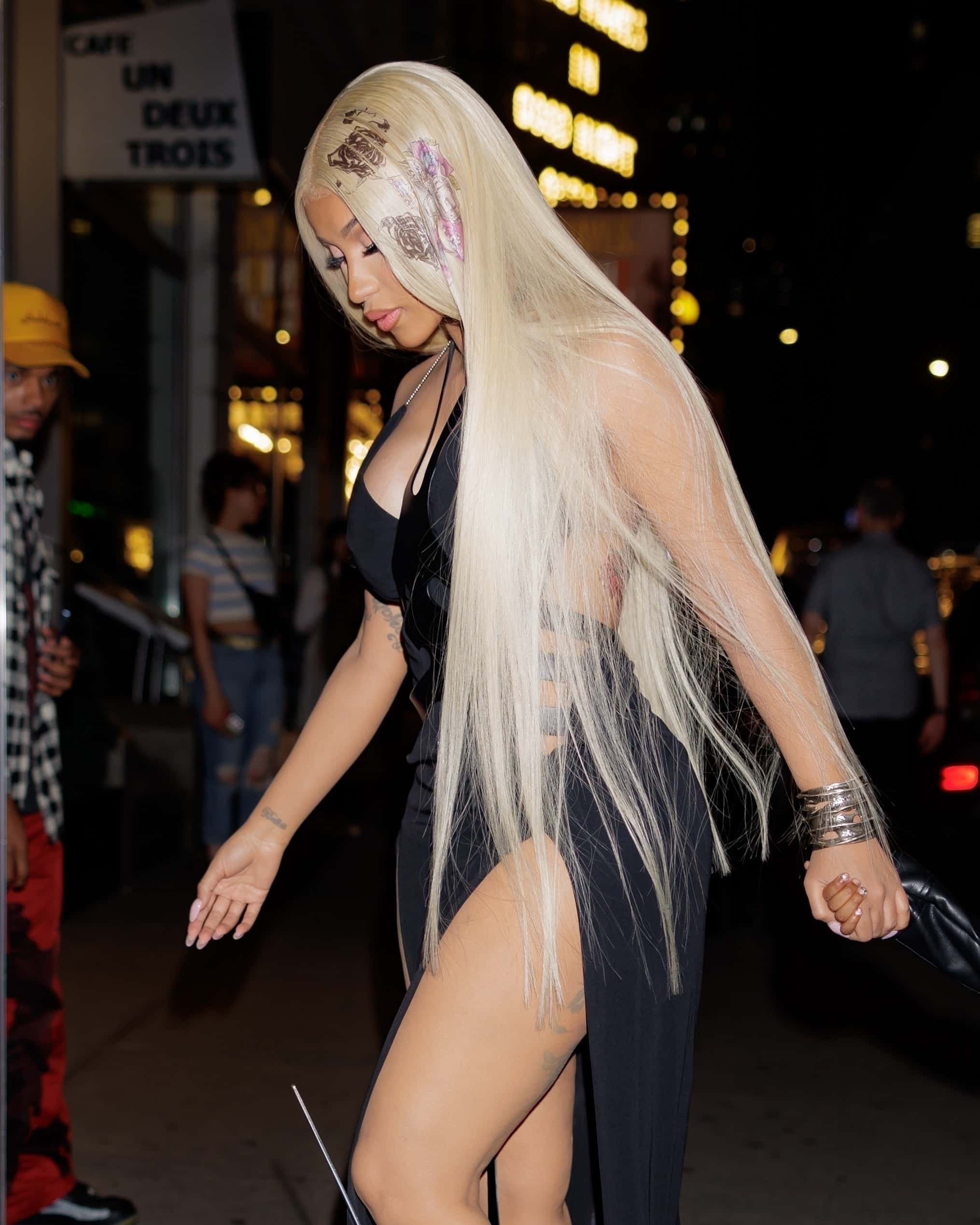 The 30-year-old superstar, who got a personalized scrapbook from the 4-year-old earlier that day, flaunted her curves in a sleek black strapless gown with a plunging neckline, waist cutouts, and thigh-high slits (Backgrid)